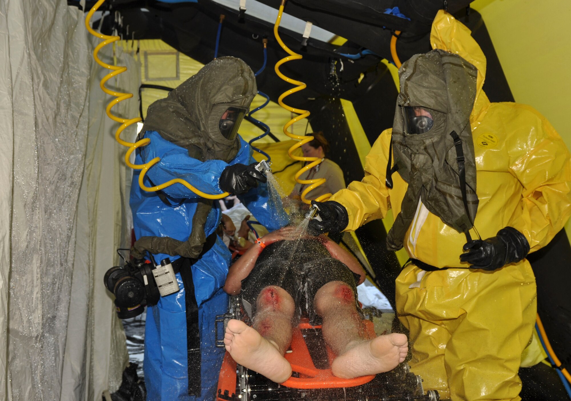 An Airman from Little Rock Air Force Base, Ark., is rinsed off as part of a simulated decontamination procedure April 22, 2014, during a field training exercise at the University of Arkansas for Medical Sciences campus. The exercise is the fourth of its kind in the U.S. and was among the largest ever held in Arkansas. (U.S. Air Force photo by Senior Airman Regina Agoha)