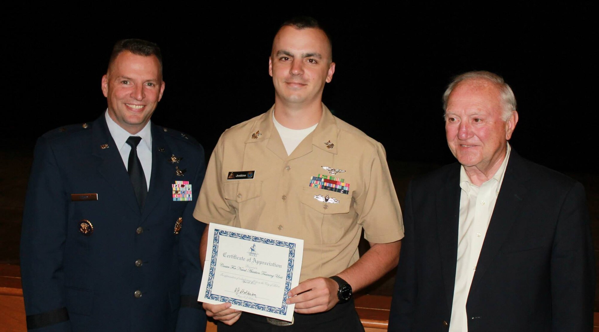 Brig. Gen. Patrick Higby, 81st Training Wing commander, and Biloxi Mayor A.J. Holloway flank Petty Officer 1st Class Jerrod Jenkins from the Keesler Center for Naval Aviation Technical Training Unit at the Biloxi Volunteer Recognition Ceremony, April 22 at the Biloxi Civic Center.  Jenkins was one of the nominees for military volunteer of the year.