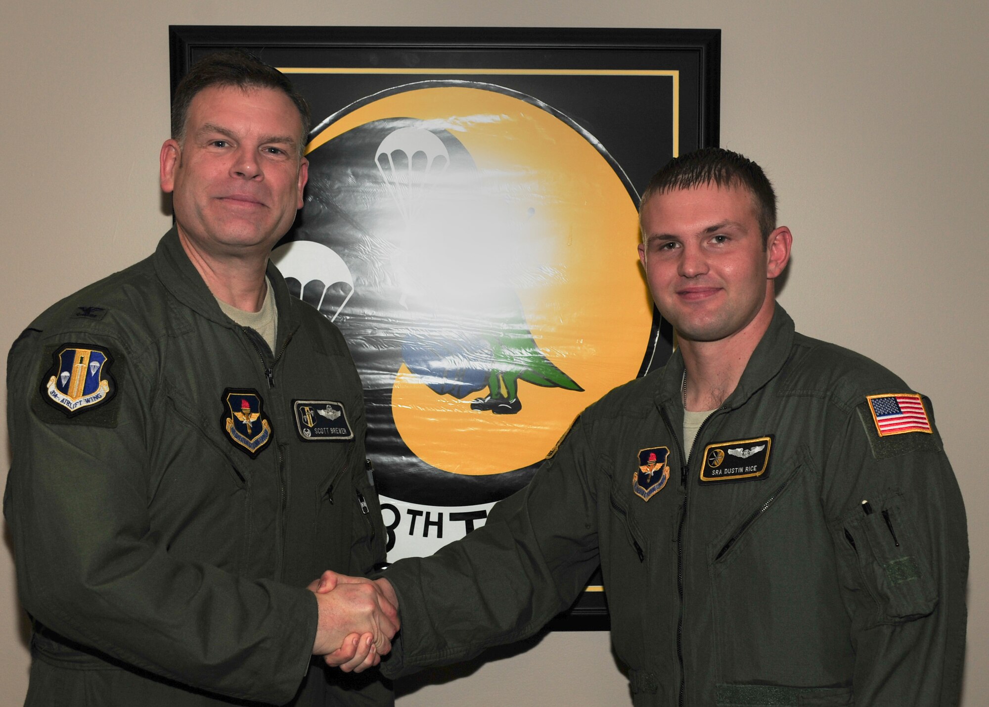 Senior Airman Dustin Rice, a 48th Airlift Squadron standardization and evaluation liaison, is congratulated by Col. Scott Brewer, 314th Airlift Wing commander, for his selection as Combat Airlifter of the Week April 28, 2014, at Little Rock Air Force Base, Ark. Rice, a Marshall, N.C. native, instructed 17 loadmaster students and logged 138 hours of flight/ground instruction to win the 48th Airlift Squadron’s “Highest Flying Hopper” award. (U.S. Air Force photo by Airman 1st Class Harry Brexel)
