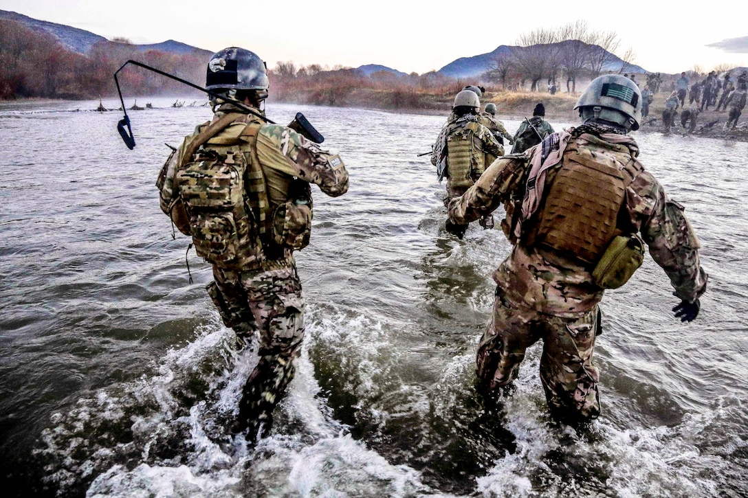 U.S. Special Forces members cross a wide river during a clearance operation in the Gaza valley of the Arghandab district in Afghanistan’s Zabul province, Dec. 11, 2013.  