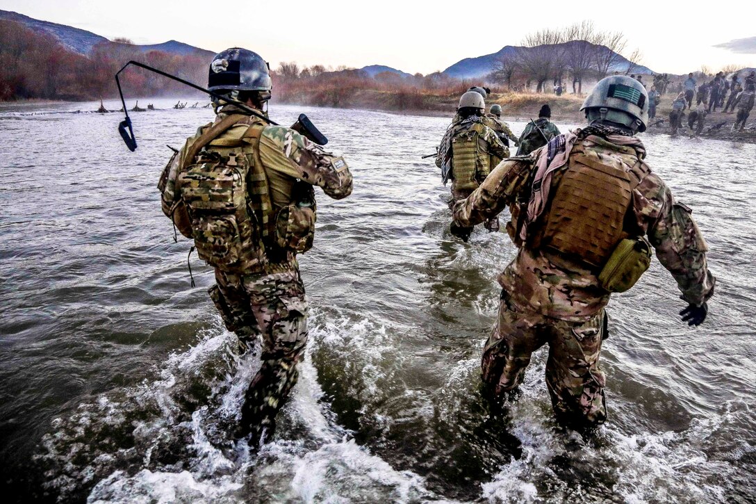 U.S. Special Forces members cross a wide river during a clearance operation in the Gaza valley of the Arghandab district in Afghanistan’s Zabul province, Dec. 11, 2013.  