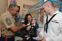 Master Sgt. Abiub Montes, native of Jacksonville, Fla., and military advisor from the Naval Mobile Construction Battalion 14 of Fort Lauderdale, Fla., and Petty Officer 3rd Class Brett Hopkins, a cryptologic technician, from Carrier Strike Group 12, visit children at the Joe DiMaggio Children's Hospital, April 30, as part of Fleet Week Port Everglades. This is the 24th annual Fleet Week in Port Everglades, South Florida’s annual celebration of the maritime services. 