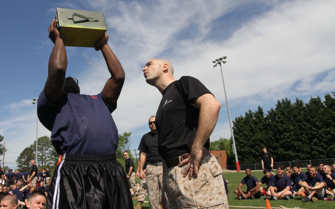U.S. Marine Corps Staff Sgt. Brian Church, the staff noncommissioned officer in charge of Recruiting Sub-Station Winston-Salem and Jersey City, N.J., native, counts ammo can lifts for Deon Settle, a poolee with Recruiting Sub Station Raleigh and Raleigh, N.C., native, during the ammo-can lift portion of the statewide pool function at North Carolina State University in Raleigh, N.C., April 26, 2014. The statewide pool function is a competition between the 13 sub-stations of RS Raleigh that tests their poolee’s strength, conditioning and mental fortitude in a series of events. (U.S. Marine Corps photo by Sgt. Dwight A. Henderson/Released) 