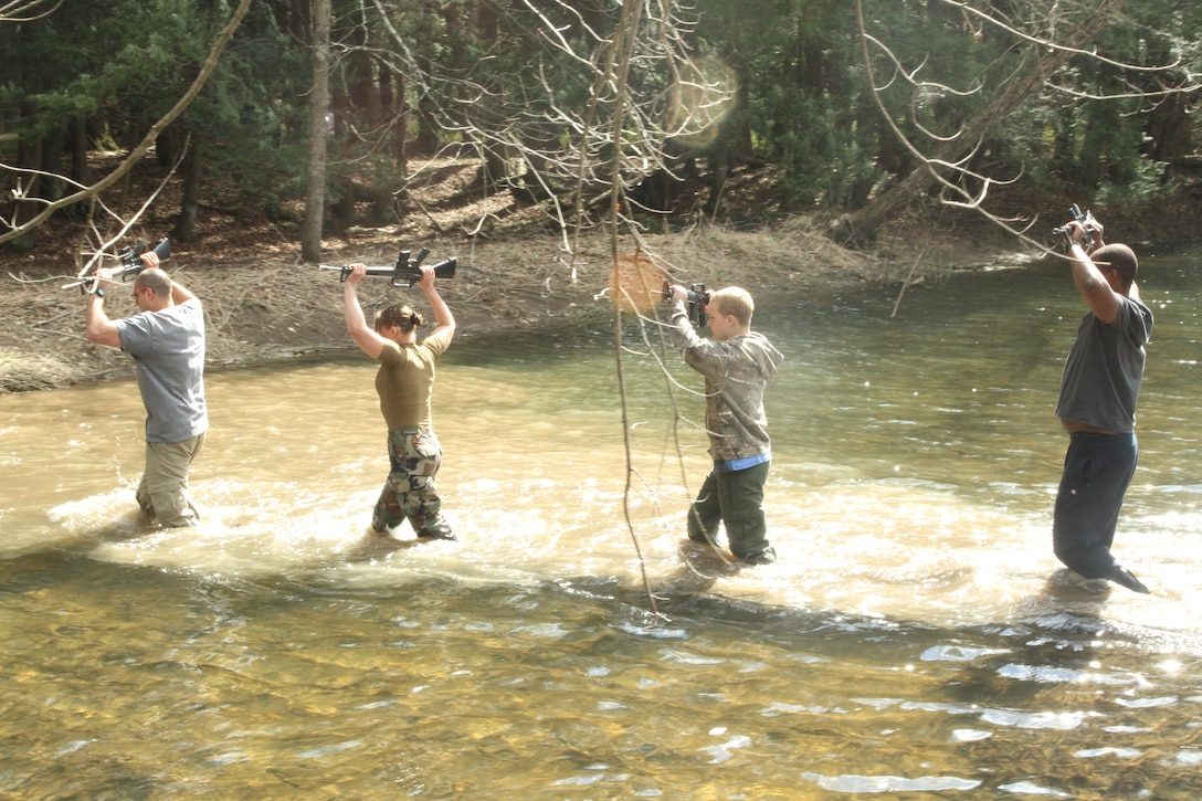 Future U.S. Marine Corps officer candidates patrol through a creek during a small unit leadership class held during an Officer Candidates School preparatory weekend at Camp Woodward, Pa. April 25-27, 2014. The purpose of the weekend was to give the candidates a realistic view of how physically, mentally and emotionally demanding OCS will be. (U.S. Marine Corps photo by Sgt. Tyler Hlavac/Released)