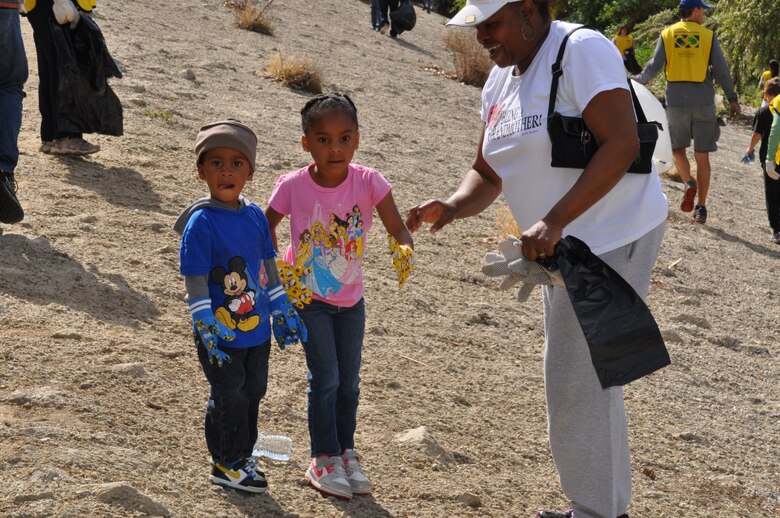 Calvin Joseph (CJ) Spencer, 2 years old and Dylan Spencer 4 years old lends a hand to their grandmother, Mary Spencer, District Deputy Chief of the Small Business Program. Volunteers from the U.S. Army Corps of Engineers Los Angeles District joined forces with hundreds of community volunteers along the Los Angeles River adjacent to Balboa Park in the Sepulveda Basin for the Friends of the Los Angeles River’s 25th La Gran Limpieza: The Great Los Angeles River Clean Up April 26.