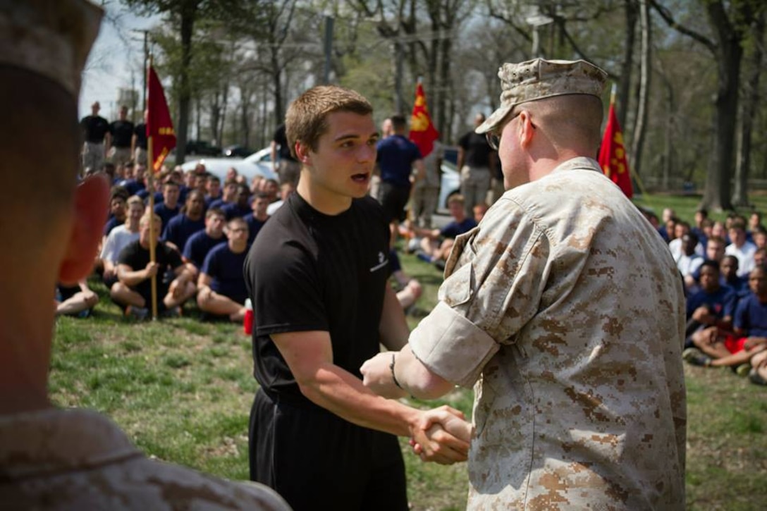 Brett Strader, a poolee with Recruiting Sub-Station Glen Burnie and native of Annapolis, Md., receives an award for outstanding performance from U.S Marine Corps Maj. Christopher S. Conner, the commanding officer of Recruiting Station Baltimore, during RS Baltimore’s statewide pool function at Aberdeen Proving Grounds, Aberdeen, Md., April 26, 2014. The pool function allowed the RS to better prepare their poolees for the mental, physical and emotional stress that comes with recruit training at Marine Corps Recruit Depot Parris Island, S.C.  (U.S Marine Corps photo by Sgt. Bryan Nygaard/released)