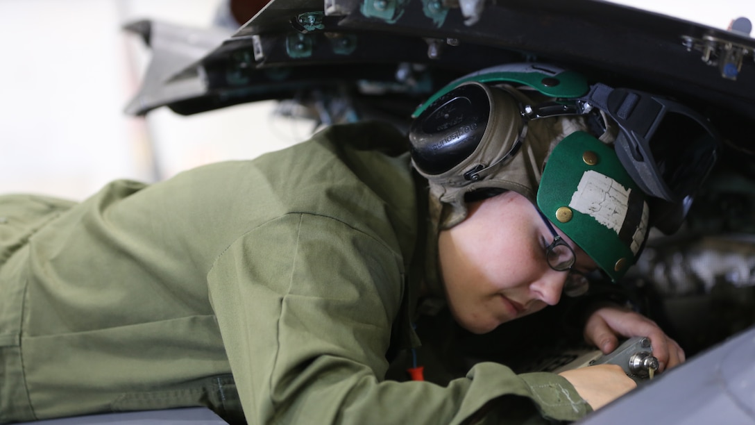 Lance Cpl. Erika Minnix takes the cannon plug off a digital electronic control unit inside of an AV-8B Harrier at Marine Attack Training Squadron 203 aboard Marine Corps Air station Cherry Point, N.C., April 21, 2014. VMAT-203 supports 2nd Marine Aircraft Wing by training Harrier pilots. Minnix is an aircraft communications navigation radar systems technician with the squadron.     