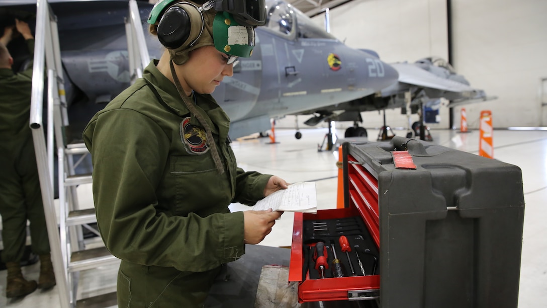 Lance Cpl. Erika Minnix checks a shortage sheet while repairing an aircraft at Marine Attack Training Squadron 203 aboard Marine Corps Air Station Cherry Point, N.C., April 21, 2014. A shortage sheet checks the availability of a specific tool and keeps track of all tools to lower the possibility of aircraft hazards. Minnix is an aircraft communications navigation radar systems technician with the squadron.