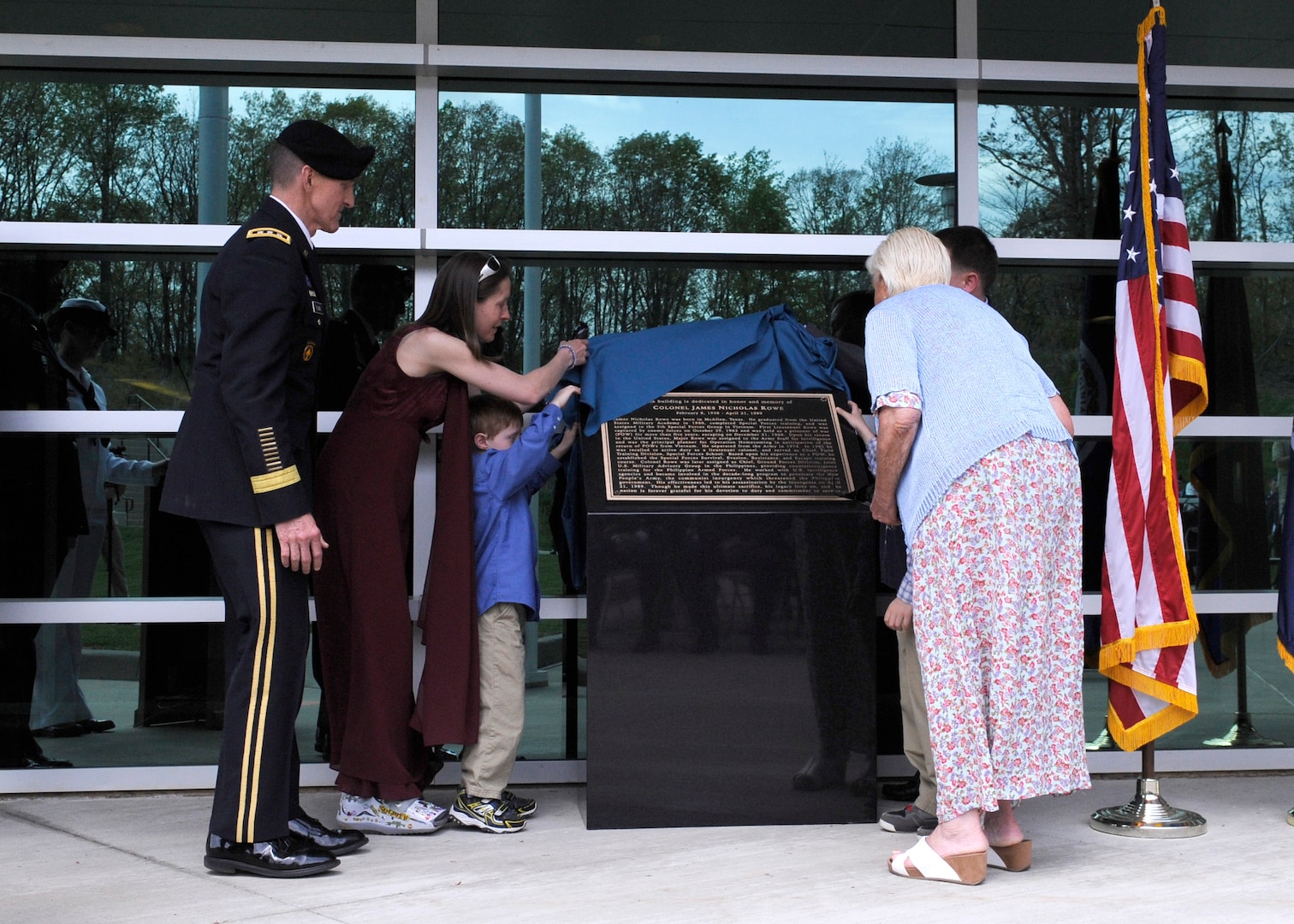 The family of the late Col. James N. Rowe as well as DIA Director Lt. Gen. Michael T. Flynn unveil a building dedication plaque during a ceremony in honor of Rowe at the DIA Field Support Activity Rivanna Station in Charlottesville, Va. 