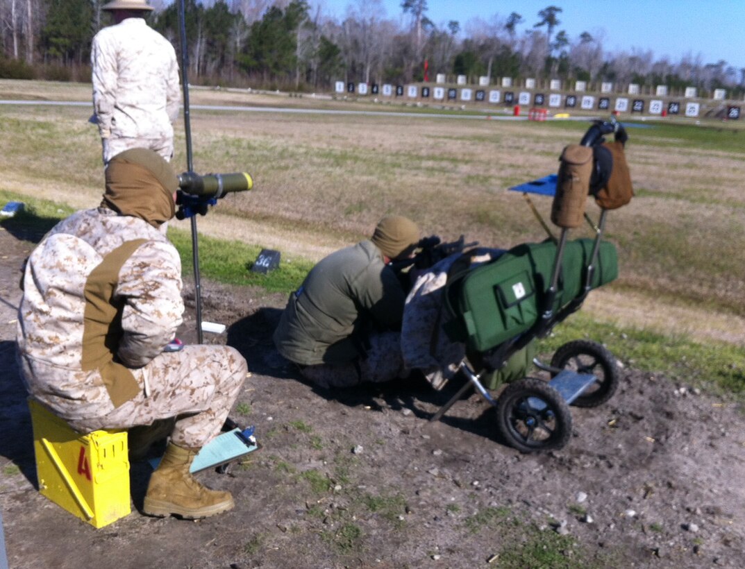 Sgt. Ryan Cordle, MCLB Albany Shooting Team member, coaches his teammate Cpl. Marcos Noyola as he fires from the 200-yard line rapid fire during the Marine Corps Eastern Division Matches held at Stone Bay, Camp Lejeune, N.C., recently. Cordle was designated coach for the team competition.