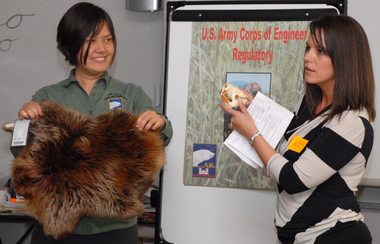 Janet Post (left) and Danielle Shack (right), regulatory specialists in the Regulatory Division, visited Turnagain Elementary School April 23 to meet with fifth and sixth-grade students to talk about wetlands and promote their studies in science, technology, engineering and mathematics. The children learned about different types of wetlands around Alaska and how they help protect from floods and pollutants. The students also felt and touched different animal pelts, bones and hides that use wetlands for their habitat.