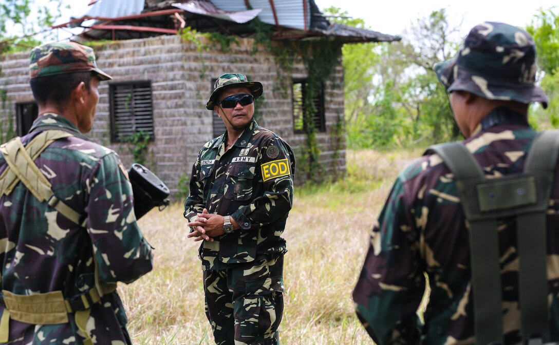 Philippine Army Tech. Sgt. Rernaur Bwenaia (right) an Explosive Ordnance Disposal (EOD) technician, instructs Philippine Army Soldiers from the 20th Infantry Battalion how to identify improvised explosive devices (IEDs) during exercise Balikatan 2014 on Fort Magsaysay, Philippines, May 1, 2014. Multiple iterations of IED exercises were completed to help the Soldiers of the 20th IB learn how to scan for and identify IEDs. U.S. Marine Corps Forces, Pacific (MarForPac) is the U.S. executive agent for the 30th iteration of the exercise, which is an annual Republic of the Philippines-U.S. military bilateral training exercise and humanitarian civic assistance engagement.