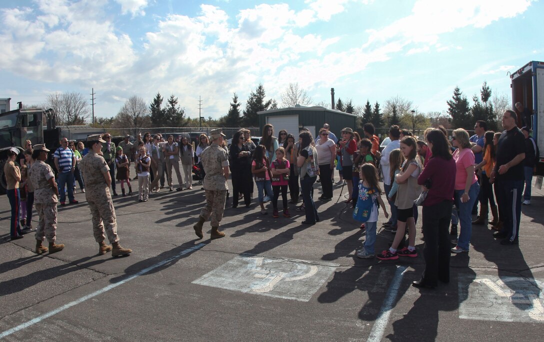 GARDEN CITY, N.Y. - Marines from the 1st Marine Corps District, Recruiting Station New York and 2nd Battalion, 25th Marine Regiment speak to Nassau County Girl Scouts May 1 at the 1MCD headquarters.  The Girl Scouts donated and helped load cookies for the Marines.  (U.S. Marine Corps photo by Lance Cpl. Brandon Thomas).