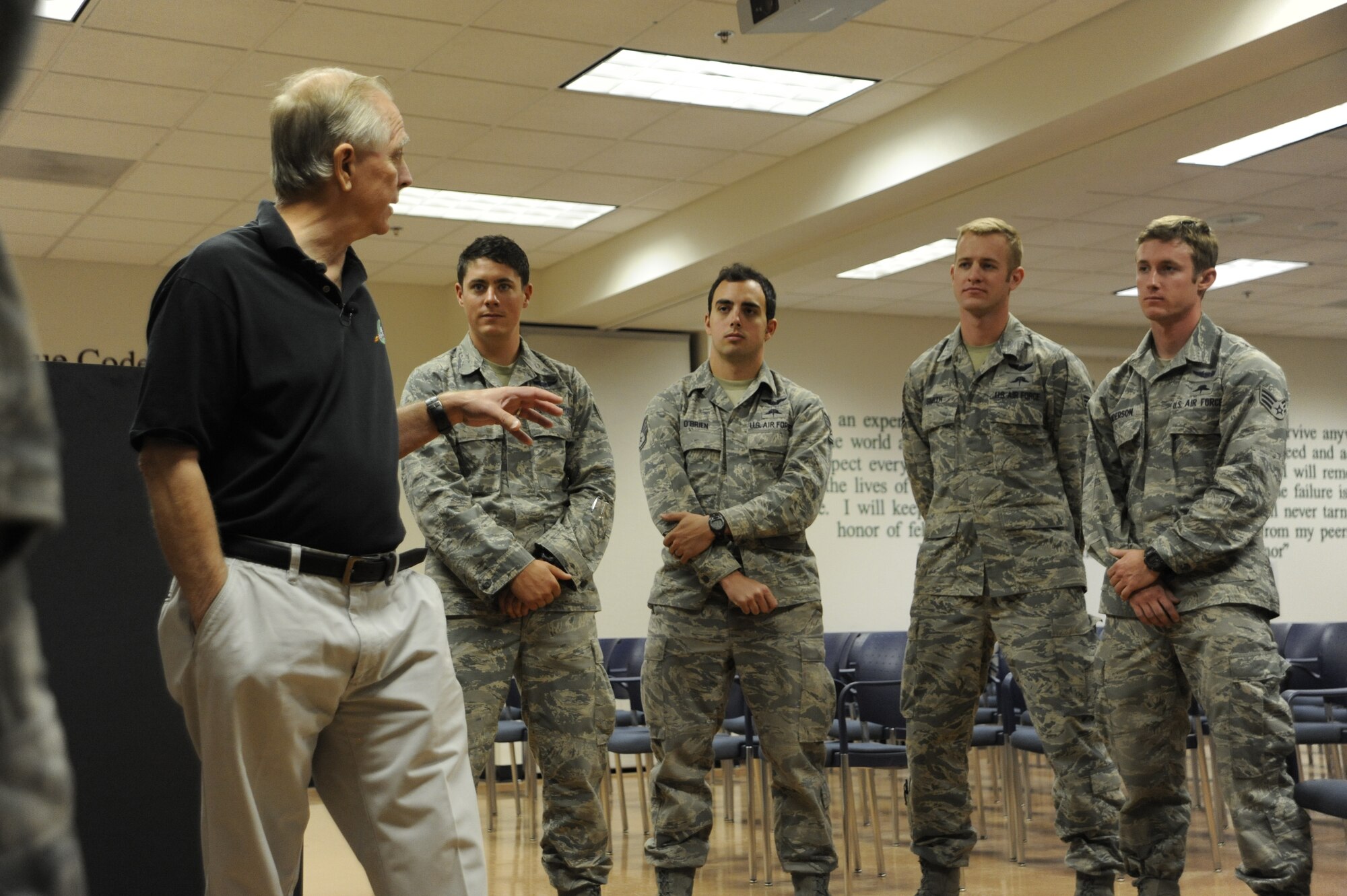 Russell Korne, a Phoenix resident, event, talks to a group of pararescuemen from the 48th Rescue Squadron at Davis-Monthan Air Force Base, Ariz., May 1, 2014. The pararescuemen saved his life when he went into cardiac arrest during the Thunder and Lightning over Arizona event near the squadrons static display. (U.S. Air Force photo by Airman 1st Class Betty R. Chevalier/Released)
