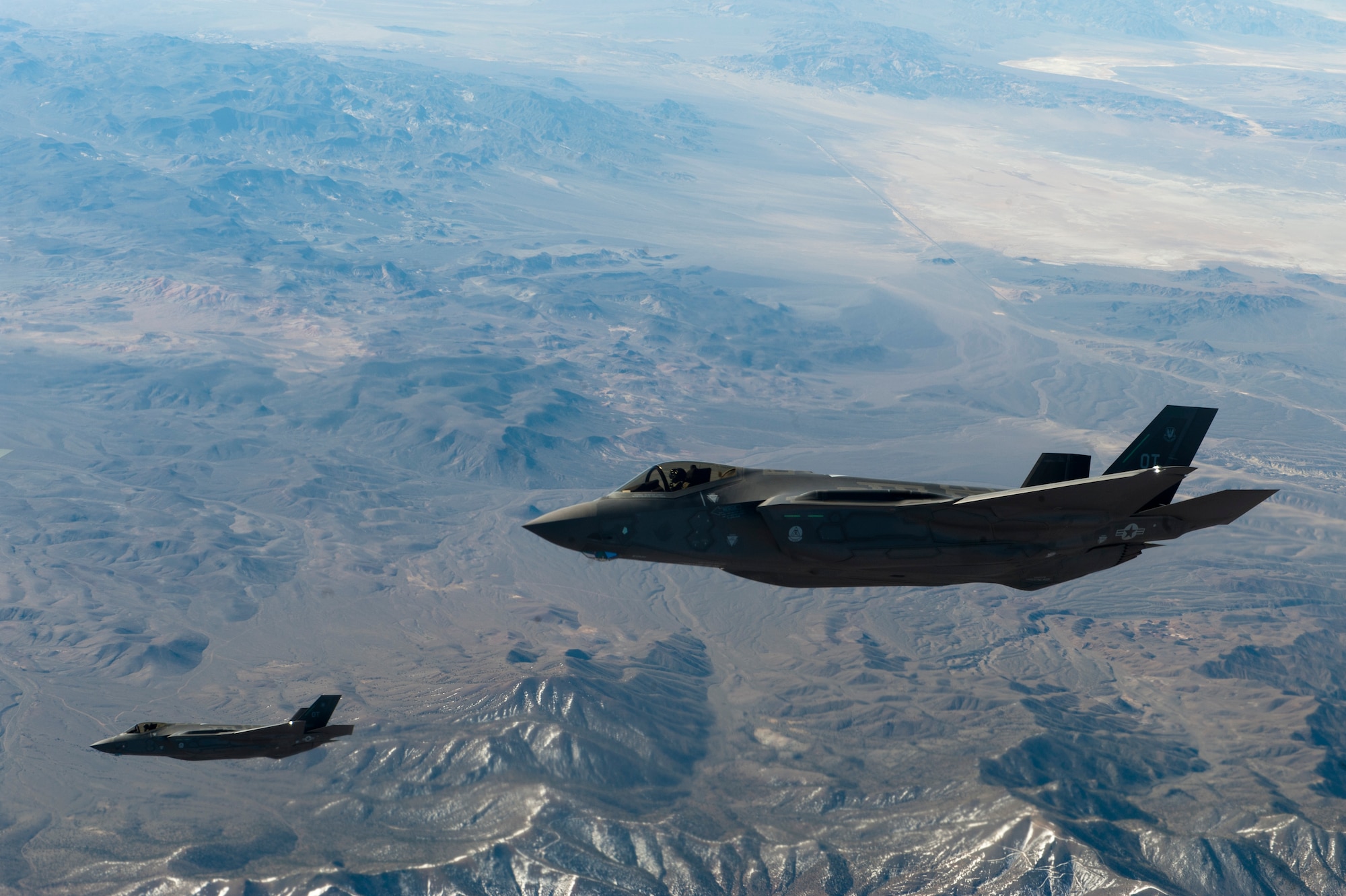Two U.S. Air Force F-35 Lightning IIs assigned to the 31st Test and Evaluation Squadron from Edwards Air Force Base, Calif. fly in formation April 29, 2014, over the California desert. The F-35’s sensor package can gather and distribute more information than any other fighter aircraft in history.  The information gathered can then be immediately shared with leaders on the ground who can make informed tactical decisions. (U.S. Air Force photo by Airman 1st Class Thomas Spangler) 