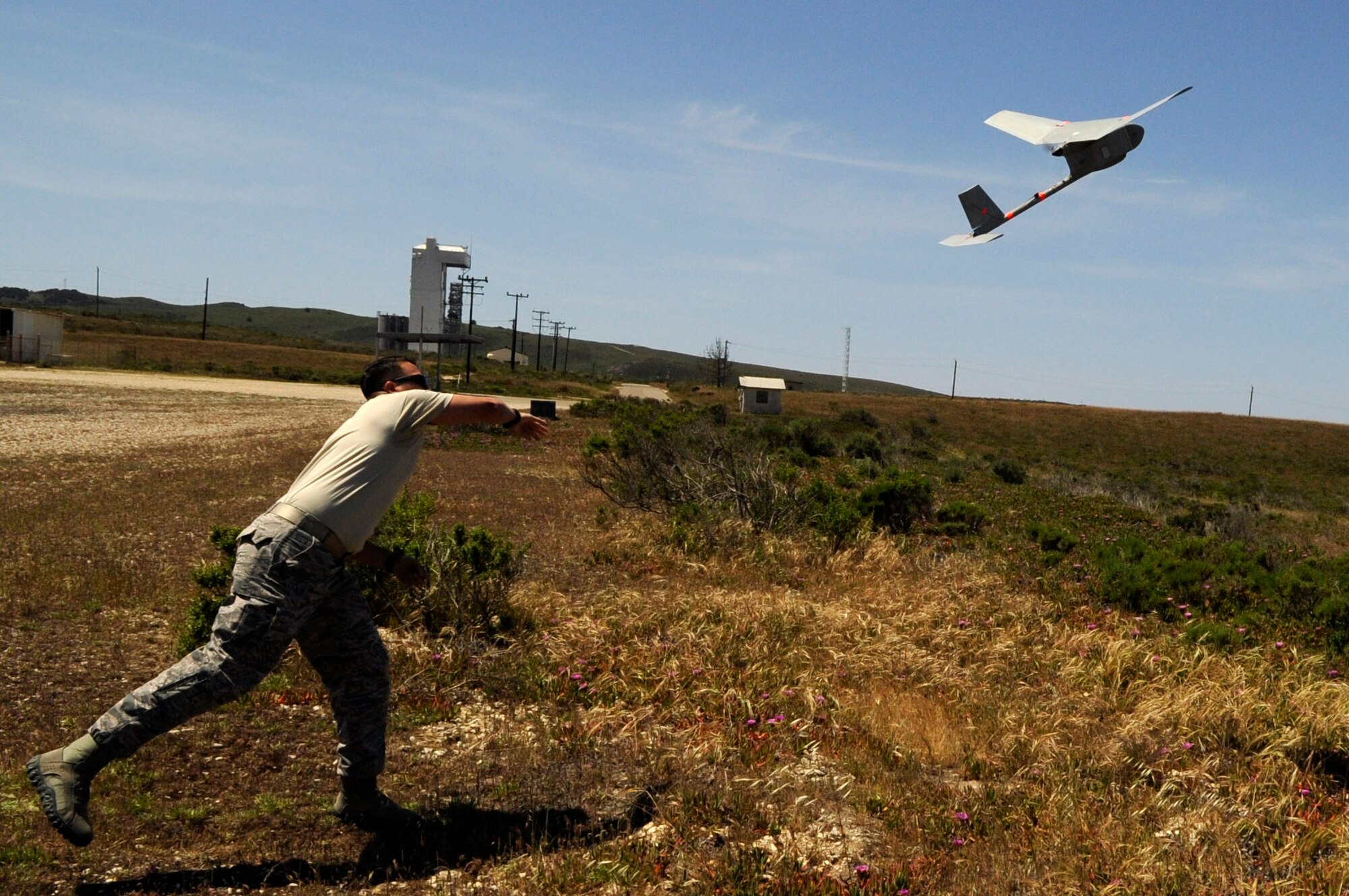 Staff Sgt. William Huster, 30th Security Forces Squadron noncommissioned officer in-charge of force protection and intelligence, launches a type of Unmanned Aerial Vehicle known as Raven-B/DDL, April 30, Vandenberg Air Force Base, Calif. The Raven requires two security forces operators and is utilized for its ample reconnaissance capabilities. (U.S. Air Force photo by Senior Airman Shane Phipps/Released)


