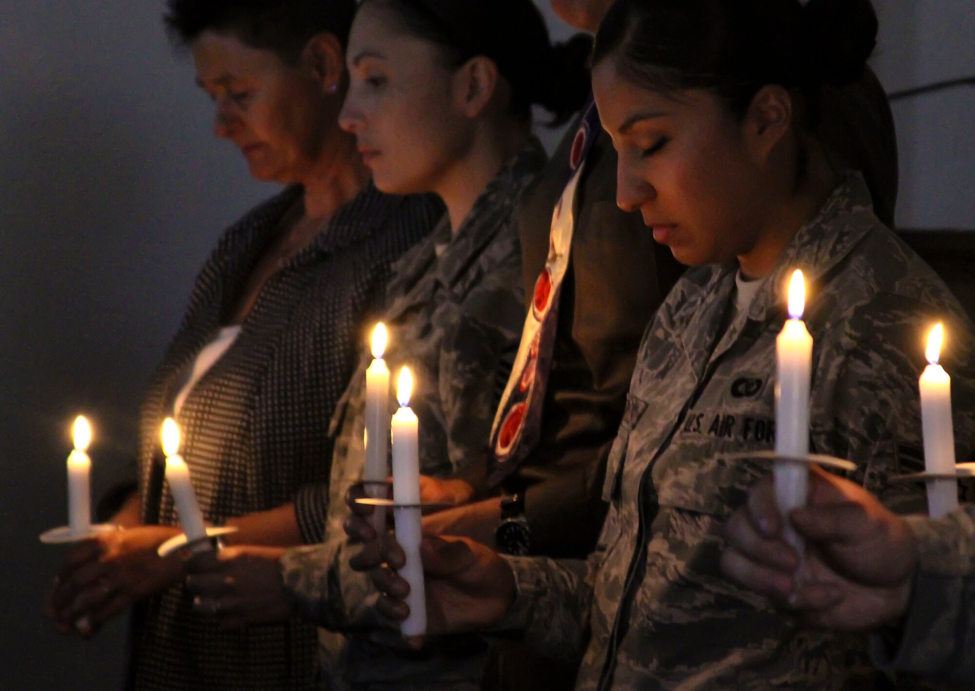 The 12th Air Force (Air Forces Southern) Holocaust Remembrance Committee hold candles during a moment of silence in remembrance of the victims of the Holocaust during the Holocaust Day of Remembrance on Davis-Monthan AFB, Ariz., May 2, 2014.  The United States Congress established the Days of Remembrance as the nation’s annual commemoration of the Holocaust and created the United States Holocaust Memorial Museum as a permanent living memorial to the victims.  (U.S. Air Force photo by Tech. Sgt. Heather R. Redman/Released)
