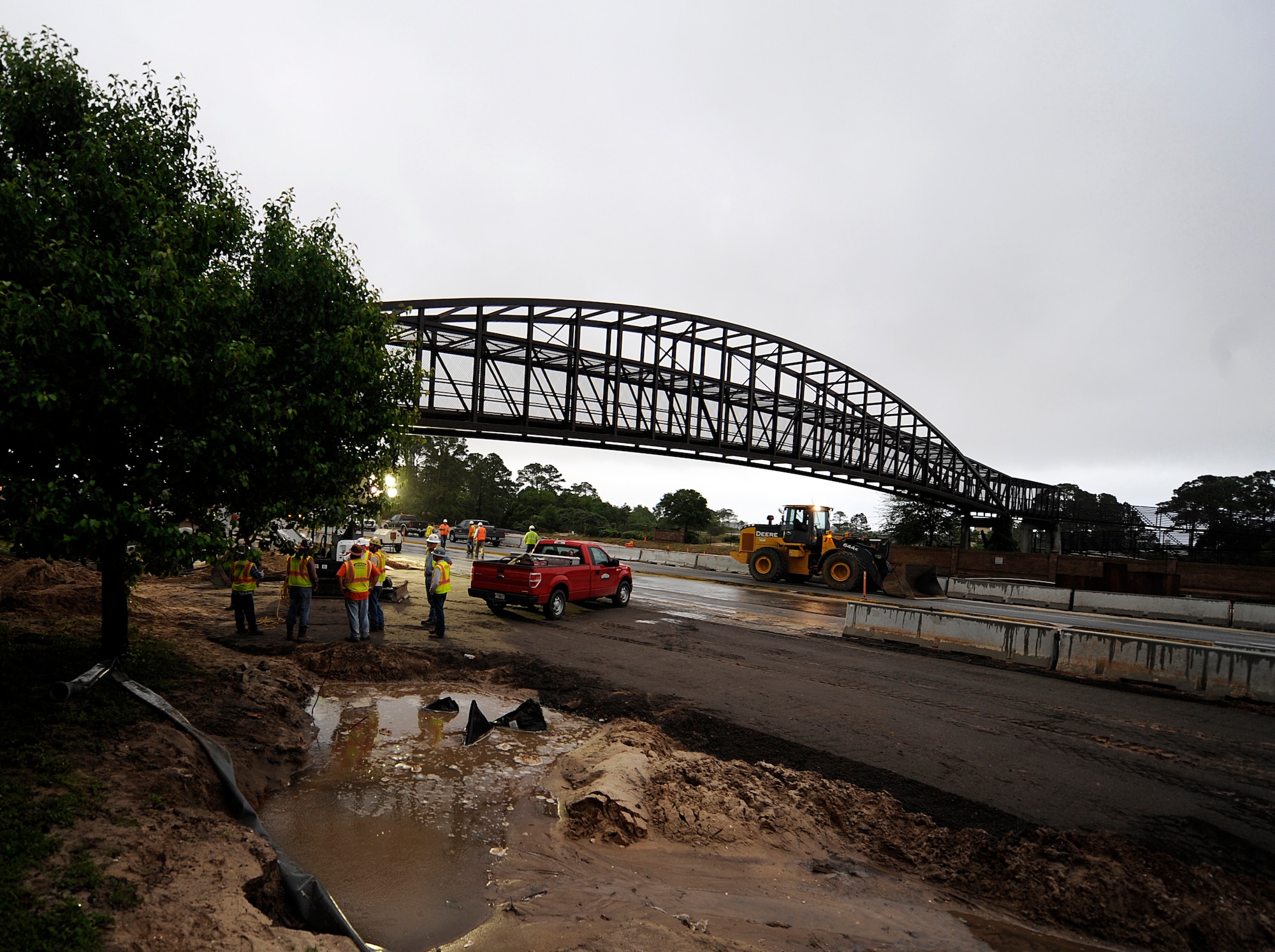 Florida Department of Transportation personnel repair the foundation of the footbridge at Hurlburt Field, Fla., April 30, 2014. Severe weather caused flooding, which damaged roads, fences and other property on the base. (U.S. Air Force photo/Staff Sgt. Jeff Andrejcik)