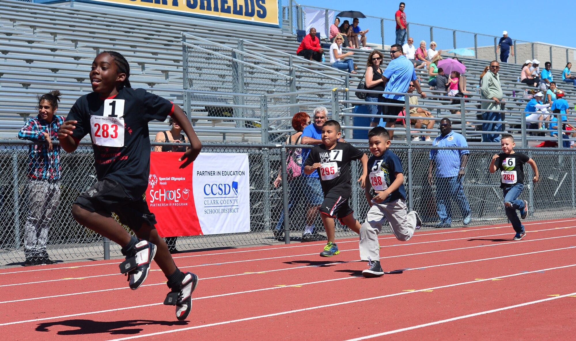 Boys competing in the 50-meter race push themselves toward the finish line during the opening ceremony of the Nevada Special Olympics at Cheyenne High School in Las Vegas May 1, 2014. Since being founded in 1968, the Special Olympics have been dedicated to empowering adults and children with intellectual disabilities through sport.