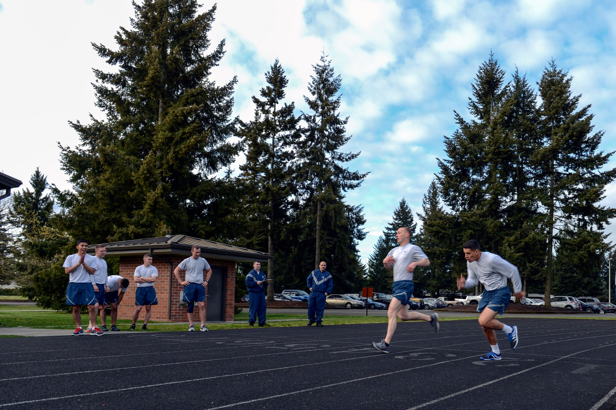 Airmen from the Civil Engineering Squadron cheer on their teammates in this month’s CE Fitness Challenge April 25, 2014, at Joint Base Lewis-McChord, Wash. The 627th CES has created a unique PT program that promotes competition and focuses on improving fitness assessment scores. (U.S. Air Force photo/Airman 1st Class Jacob Jimenez) 