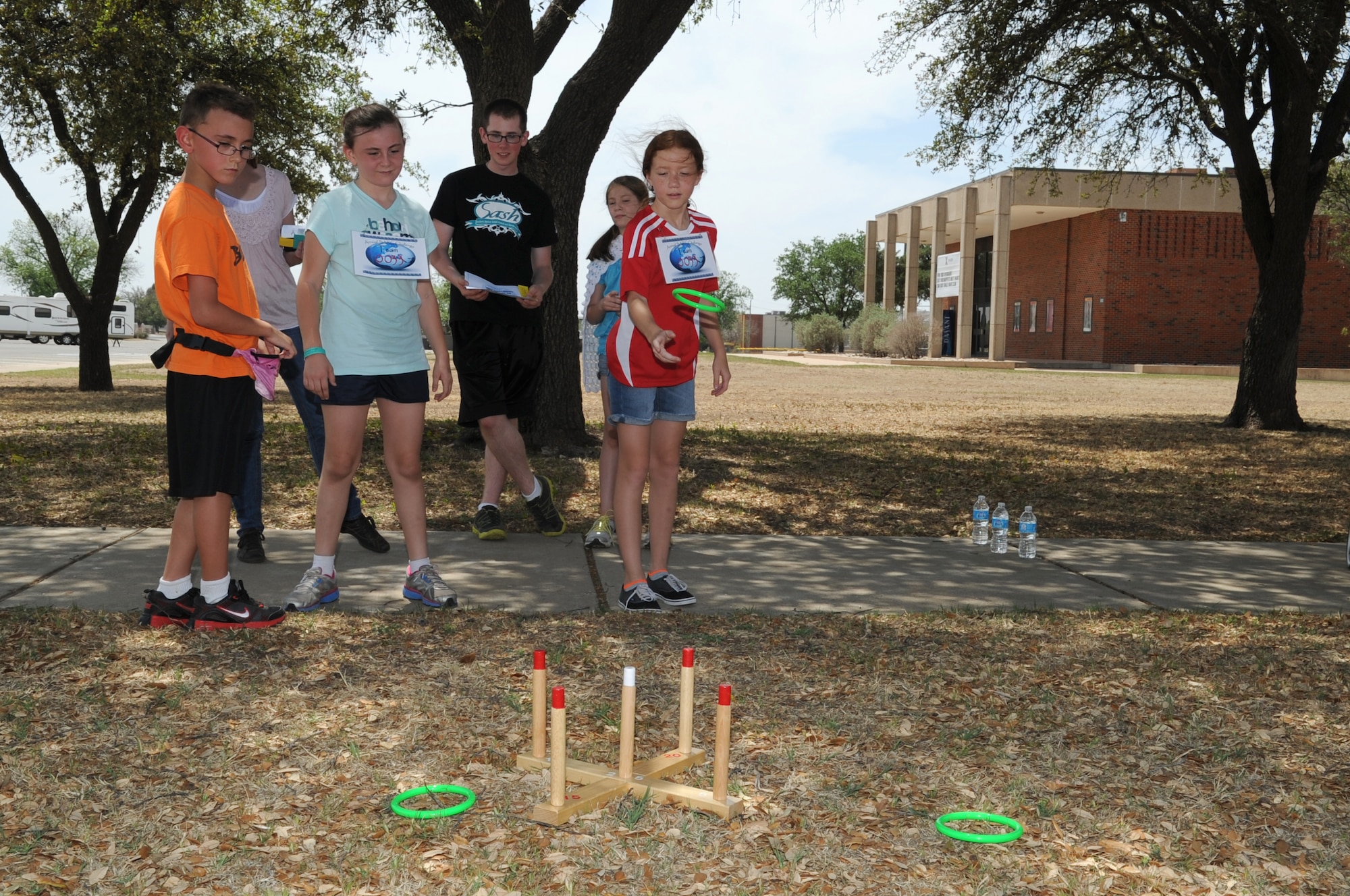 GOODFELLOW AIR FORCE BASE, Texas -- A youth watches her ring glide through the air during the 4th Annual Sexual Assault and Response Coordinator Challenge here April 26. Teams had to get four rings on the target before they received the clue to the next station. (U.S. Air Force photo/ Staff Sgt. Laura R. McFarlane)