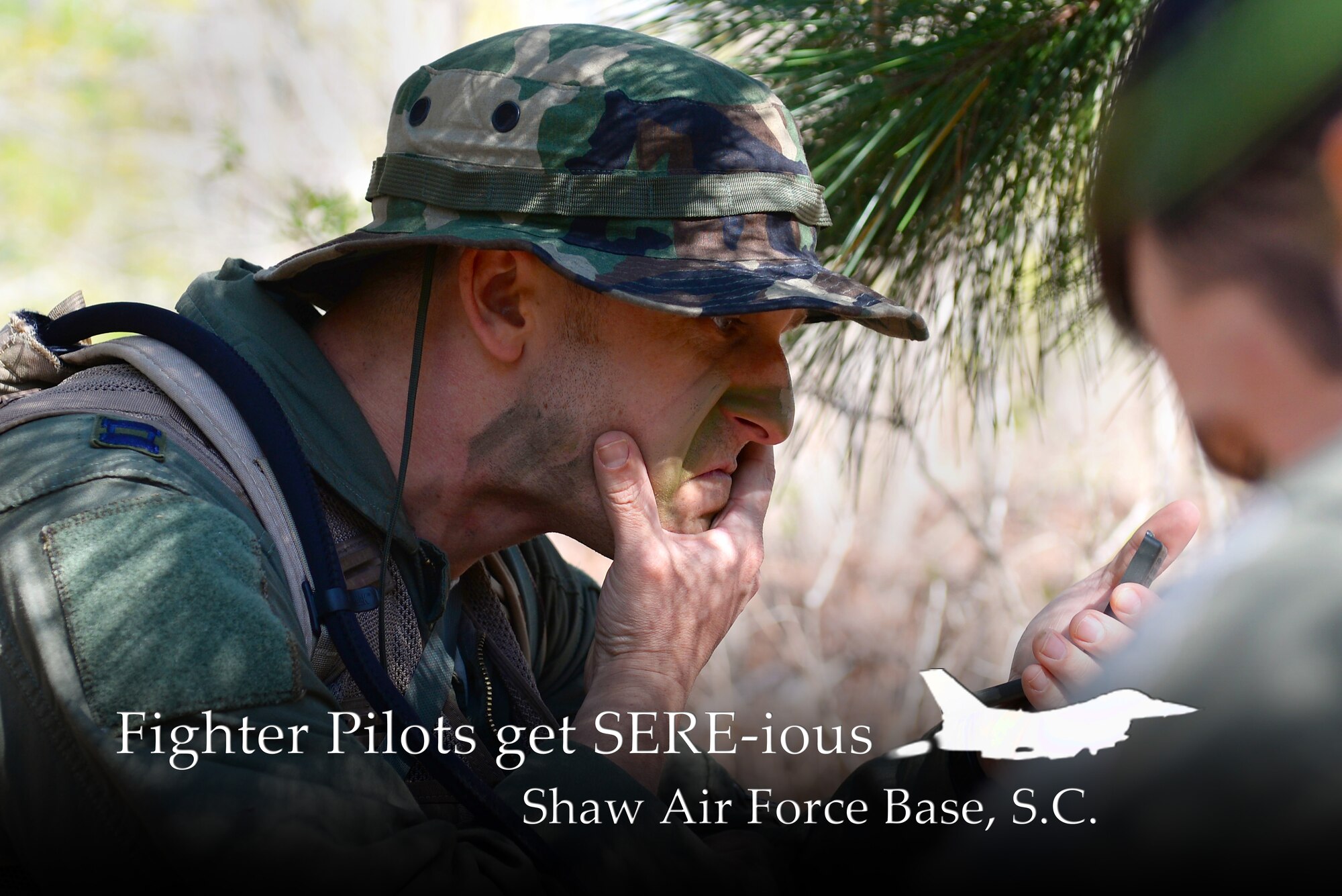 U.S. Air Force Capt. Jeremy Smallwood, 77th Fighter Squadron electronic combat pilot, applies camouflage makeup during survival, evasion, resistance, escape training at Poinsett Range near Wedgefield, S.C., April 16, 2014. The four Airmen participating in the SERE course were advised to apply camouflage as soon as possible to help blend into the environment to better avoid capture. (U.S. Air Force photo illustration by Airman 1st Class Diana M. Cossaboom/Released) 
