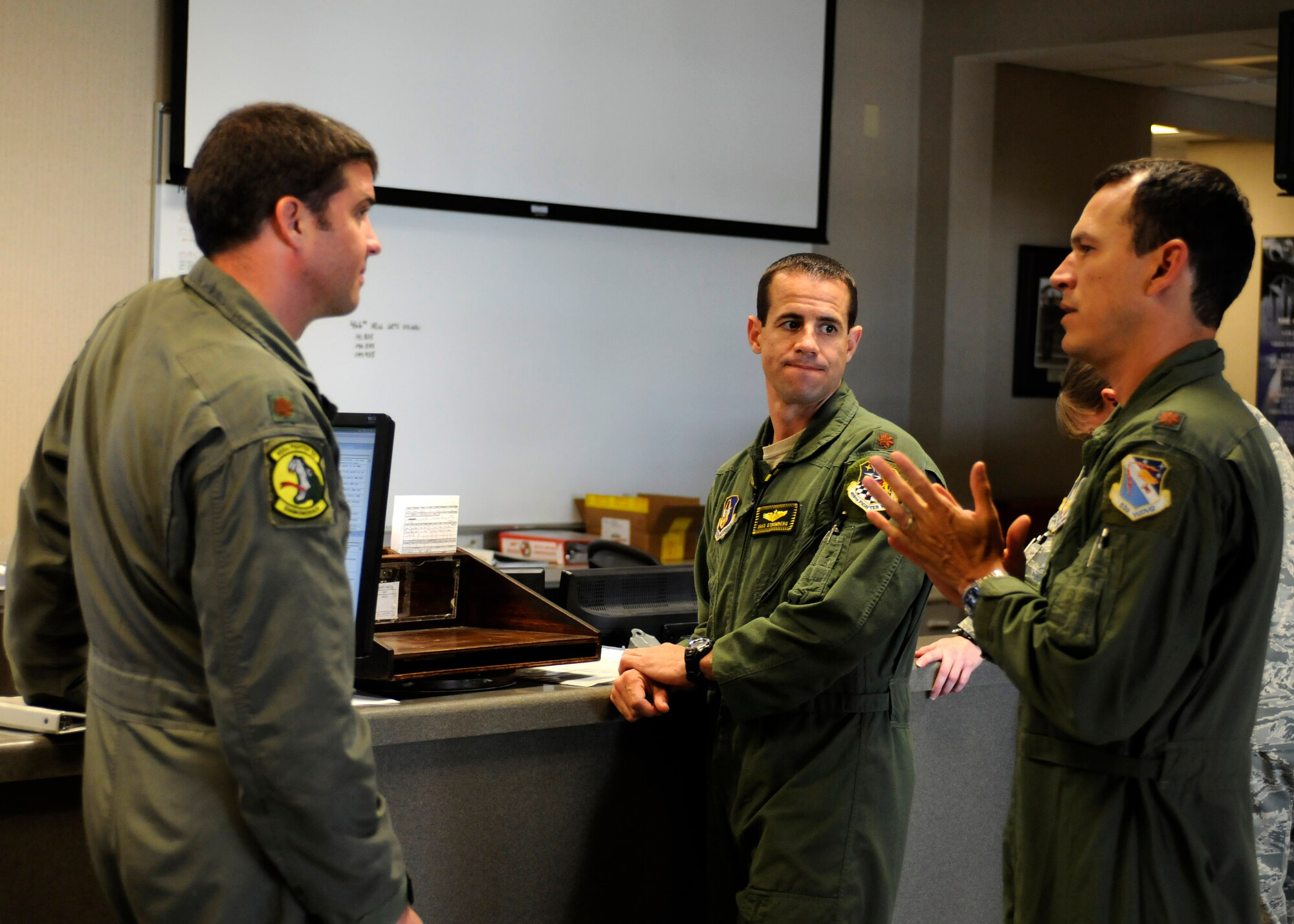Maj. Nathan Litz and Maj. Shad Stromberg both pilots with the wing’s 466th Fighter Squadron, and Maj. Jeremy Castor, pilot with the 85th Test and Evaluation Squadron, review mission plans today at Eglin Air Force Base, Fla.  Pilots from Hill’s 419th and 388th Fighter Wings spent their annual training integrating with the 85th TES. (U.S. Air Force photo/Senior Airman Allen Stokes) 