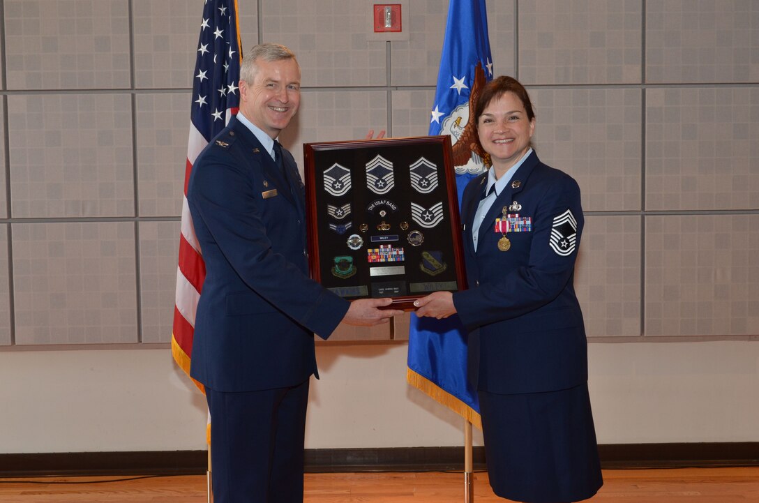 After 22 years of service, we wish Chief Carol Wiley the best as she begins her retirement.  At her retirement ceremony, she is presented with a collage of ranks and ribbons celebrating her career with the Air Force. (US Air Force photo by SMSgt Bob Kamholz/released)
