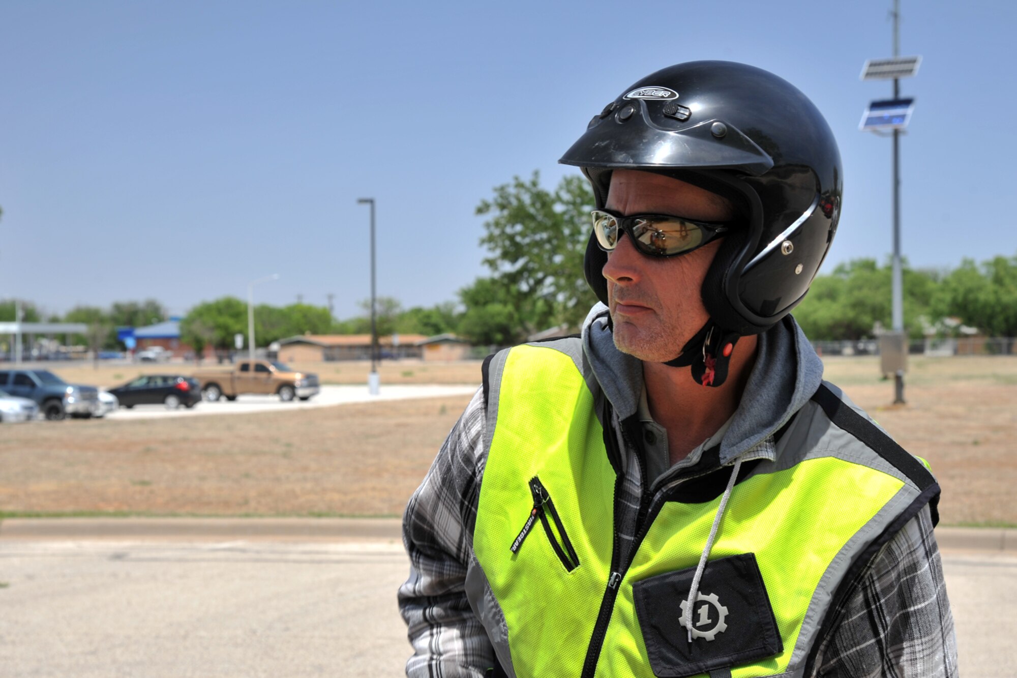 GOODFELLOW AIR FORCE BASE, Texas – Brian J. Davis, 17th Communications Squadron Communications Security manager, wears a certified helmet, sunglasses and vest at the multimedia center here April 30. Davis makes sure he wears the appropriate protective gear required to ride his motorcycle on a Defense Department installation. (U.S. Air Force photo/ Airman 1st Class Devin Boyer)