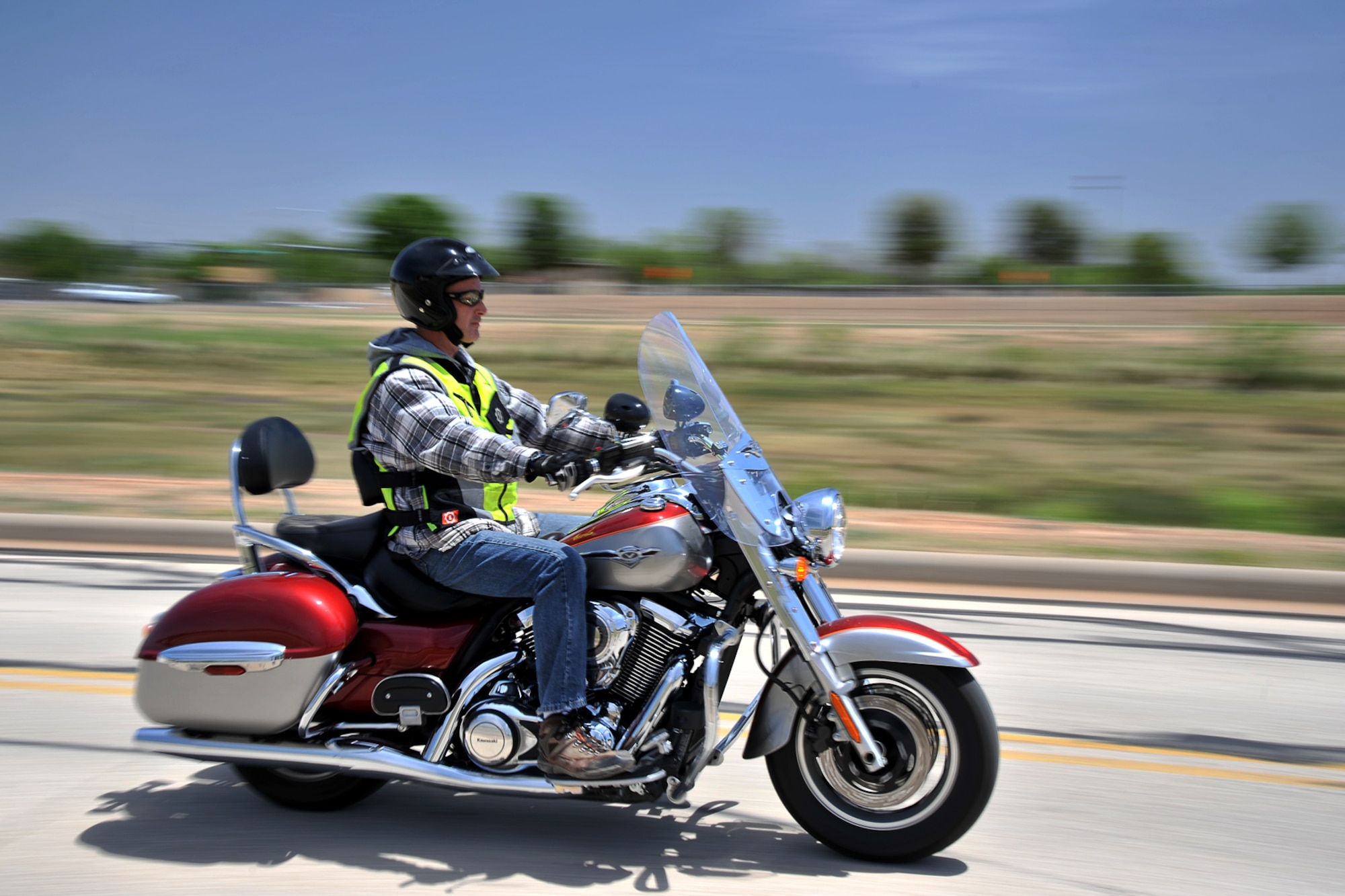 GOODFELLOW AIR FORCE BASE, Texas – Brian J. Davis, 17th Communications Squadron Communications Security manager, cruises by on his motorcycle at the multimedia center here April 30. Davis practices motorcycle safety by wearing a certified helmet, gloves and other protective gear. (U.S. Air Force photo/ Airman 1st Class Devin Boyer)