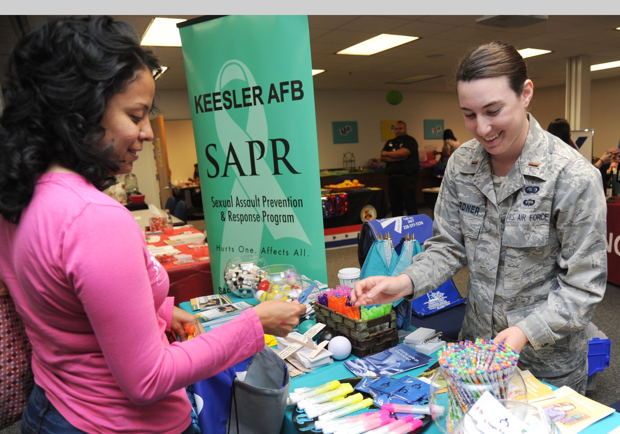 The spouse of Tech. Sgt. Adam Lougee, 335th Training Squadron, receives educational information from 2nd Lt. Tawny Gardner, 81st Force Support Squadron,  at the sexual assault prevention and response program booth during Pamper Me Day for military spouses May 1, 2014, at the Sablich Center, Keesler Air Force Base, Miss.  Keesler’s Airman & Family Readiness Center has hosted the event for the past 10 years, offering spouses free manicures, hair styling, makeup and massages.  (U.S. Air Force photo by Kemberly Groue)