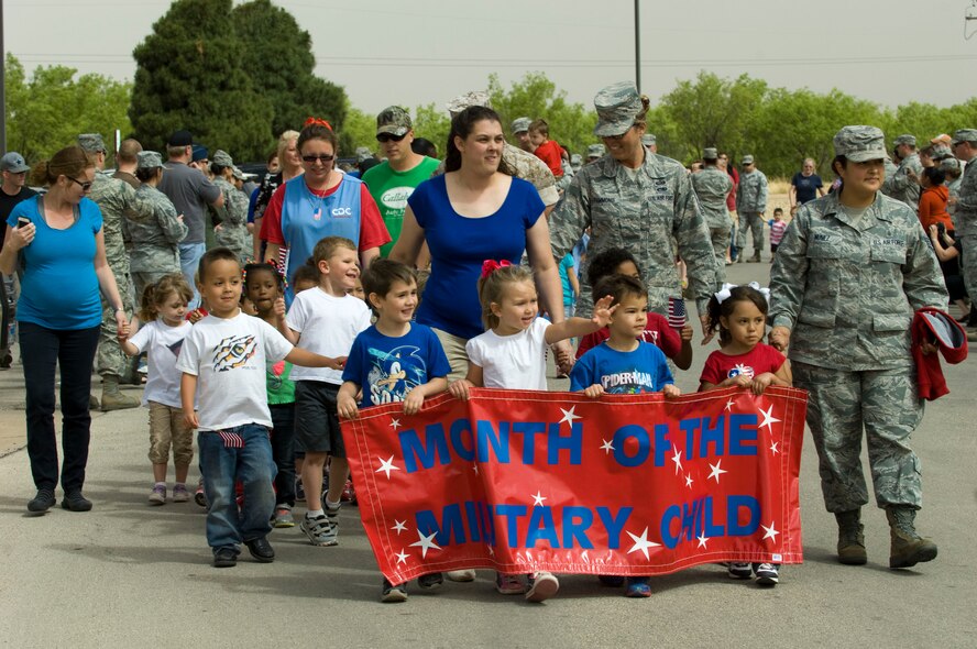 Dyess Airmen and their children participate in the Month of the Military Child parade April 29, 2014, at Dyess Air Force Base, Texas. The contributions of military children were celebrated across the Department of Defense, as April was designated the Month of the Military Child by Defense Secretary Caspar W. Weinberger in 1986. (U.S. Air Force photo by Airman 1st Class Kylsee Wisseman/Released)