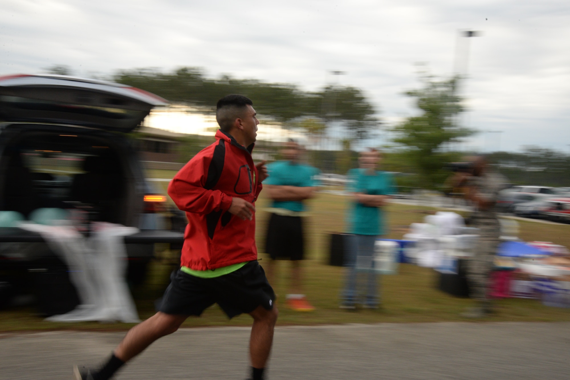 A Team Shaw member sprints the final feet of a 5K Sexual Assault Prevention and Response run at Shaw Air Force Base, S.C., May 2, 2014. More than 800 people participated in the run to help raise awareness and collect donations for victims of sexual assault and sexual harassment. (U.S. Air Force photo by Airman 1st Class Michael A. Cossaboom/Released)