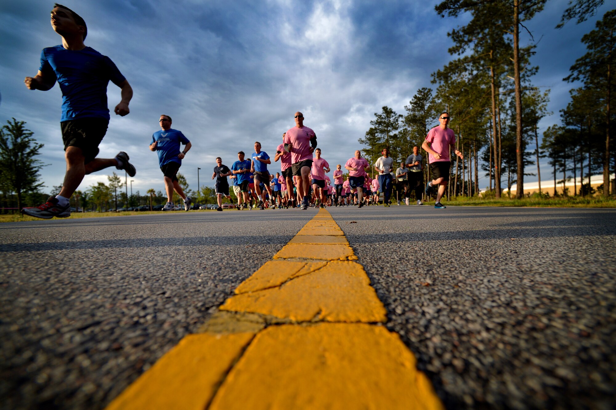 Airmen, Soldiers, civilians and family members jockey for position as they leave the starting line at the beginning of a 5K run, May 2, 2014 at Shaw Air Force Base, S.C. Team Shaw’s Sexual Assault Prevention and Response office hosted the run to promote sexual assault awareness and prevention. (U.S. Air Force photo by Staff Sgt. Kenny Holston/Released)