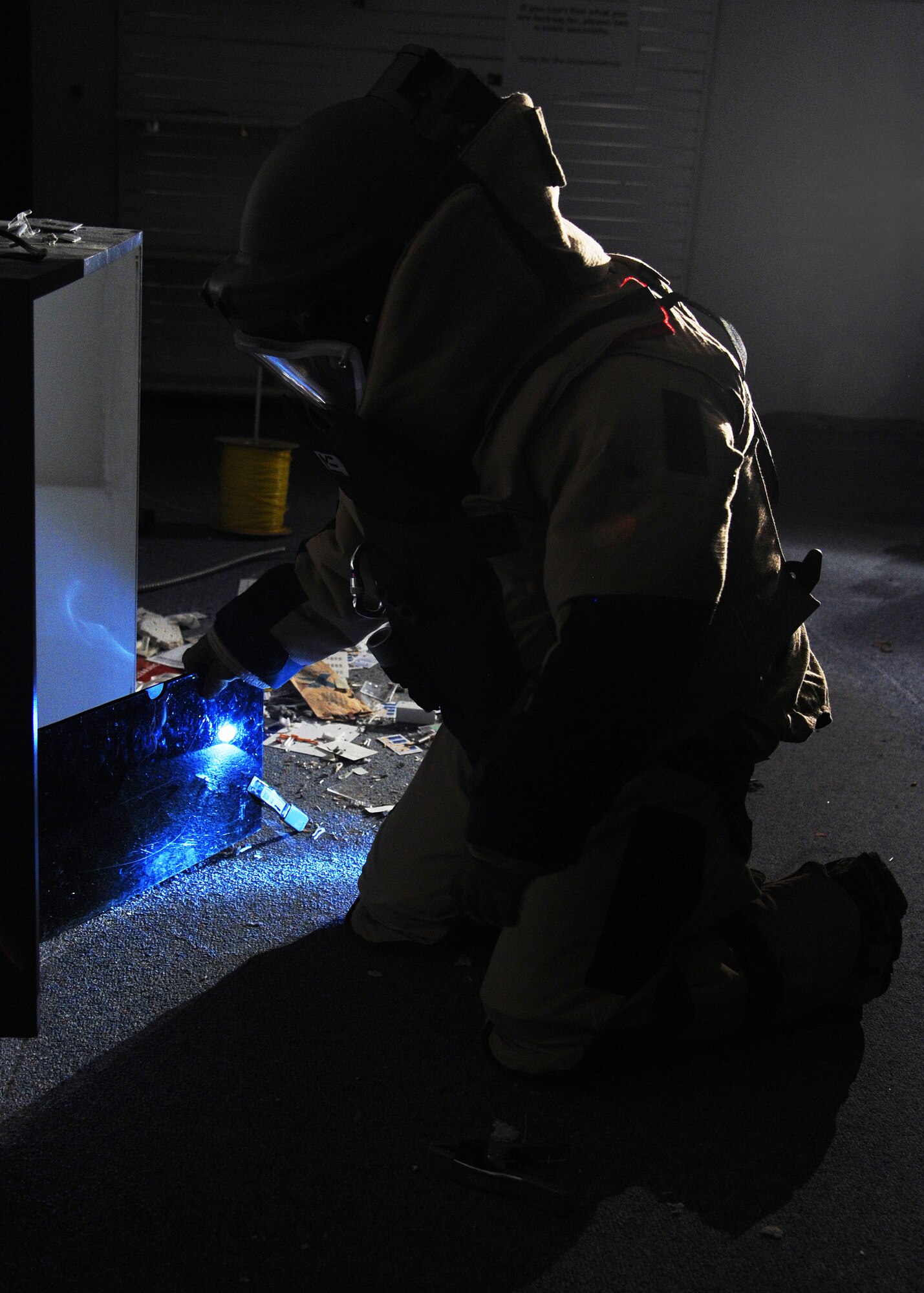 James Tilton, 341st Civil Engineer Squadron Explosive Ordnance Disposal operator, positions x-ray film before taking an x-ray of a simulated improvised explosive device during an exercise scenario at the old base exchange April 29. Tilton worked with two other members during the exercise – one person to maintain all of the tools he needed, and another to remotely operate the EOD robot. (U.S. Air Force photo/Senior Airman Cortney Paxton)