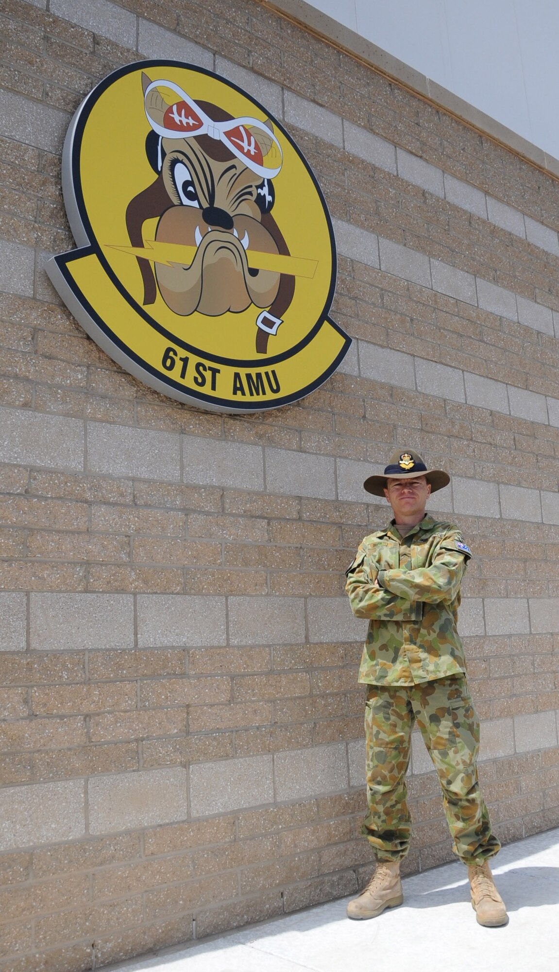 Maj. Nathan Draper, 61st Aircraft Maintenance Unit participant maintenance liaison officer, poses April 22 in front of the 61st AMU. Draper is the first Royal Australian air force officer to arrive at Luke Air Force Base. (U.S. Air Force photo/Staff Sgt. Luther Mitchell Jr.)