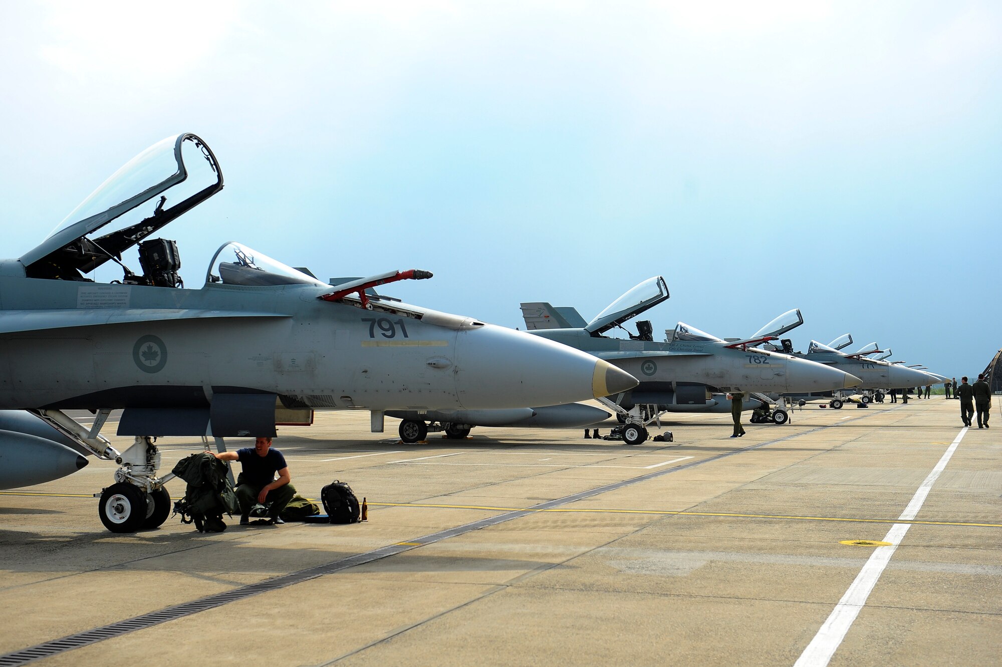 Royal Canadian Air Force CF-18 fighter aircraft are parked on the flightline May 1, 2014, at Spangdahlem Air Base, Germany. The Canadian Armed Forces are one of the major contributors to NATO operations since the founding of the Alliance 65 years ago. The 52nd Fighter Wing and the 726th Air Mobility Squadron continuously strengthen NATO partnerships by providing logistics and support during allied operations. (U.S. Air Force photo by Senior Airman Rusty Frank/Released) 