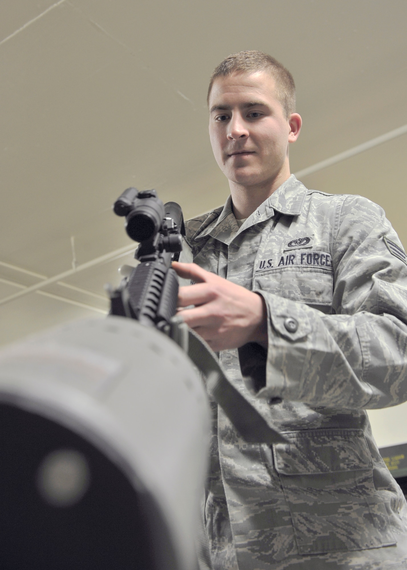 Senior Airman Travis Marshall, 354th Civil Engineer Squadron expeditionary engineering programs manager, ensures a weapon is cleared April 24, 2014, Eielson Air Force Base, Alaska. The CES has an armory capable of holding over 300 weapons. (U.S. Air Force photo by Senior Airman Ashley Nicole Taylor/Released)