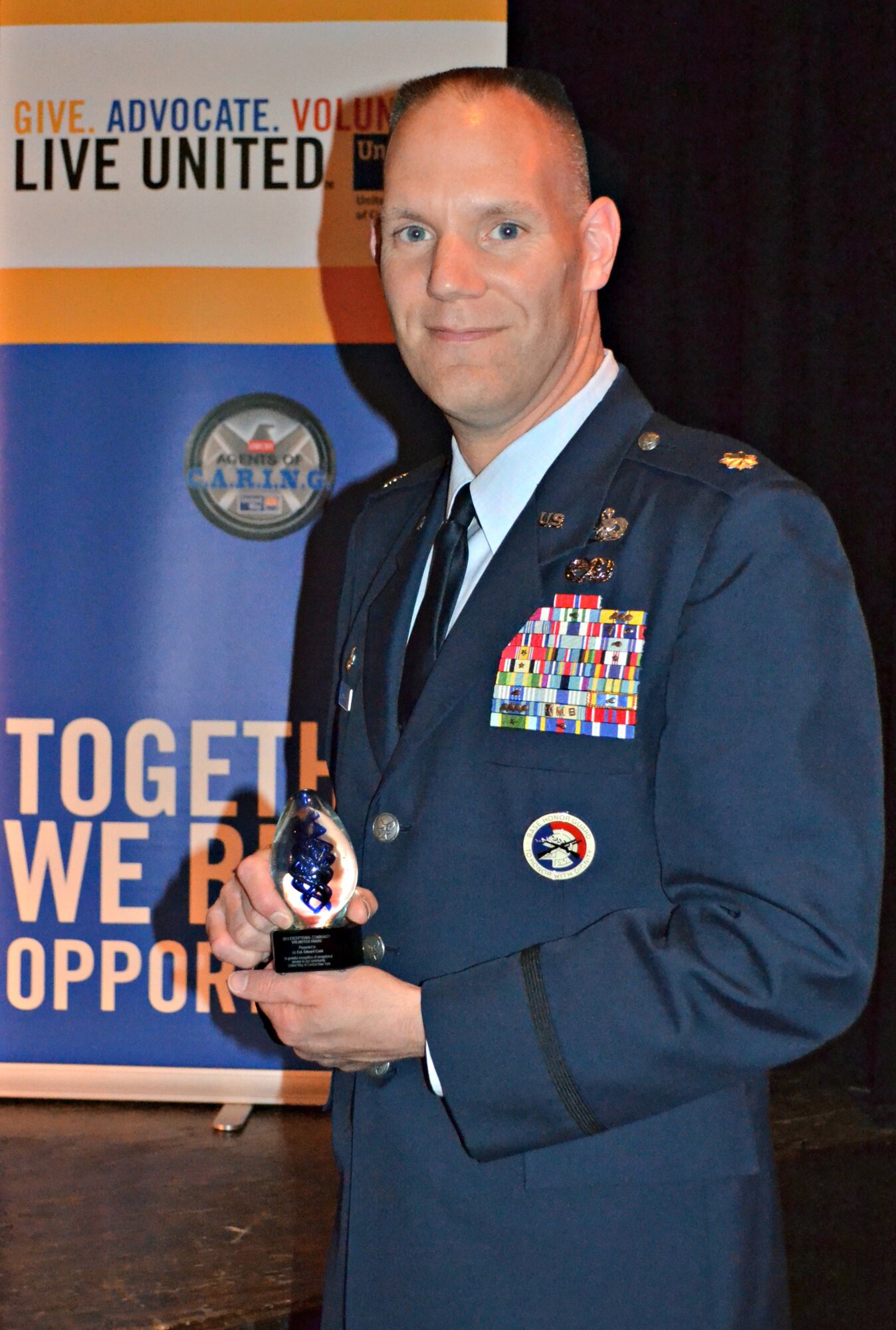 Lt. Col. Edward Cook poses with The United Way of Central New York Exceptional Community Volunteer of the Year Award.