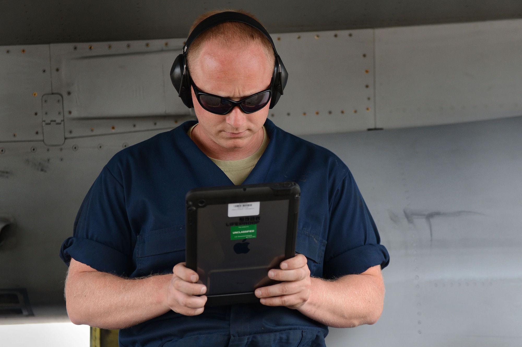 Senior Airman Matthew Leke, 20th Aircraft Maintenance Squadron, 55th Aircraft Maintenance Unit tactical aircraft maintainer, navigates an iPad version of a technical order manual instead of an older electronic version at Shaw Air Force Base, S.C., April 29, 2014.  The 55th AMU tested the iPads’ reliability on the flight line. (U.S. Air Force photo by Airman 1st Class Jensen Stidham/Released)