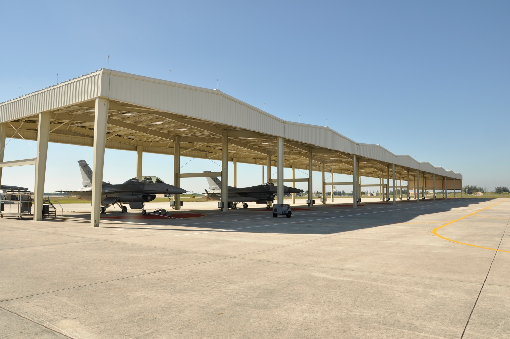 F-16 aircraft from the 482nd Fighter Wing sit under newly installed sunshades at Homestead Air Reserve Base, Fla.  The sunshades will help protect both Airmen and aircraft from the sometimes harsh weather conditions on the flightline. (U.S. Air Force photo/Senior Airman Nicholas Caceres)