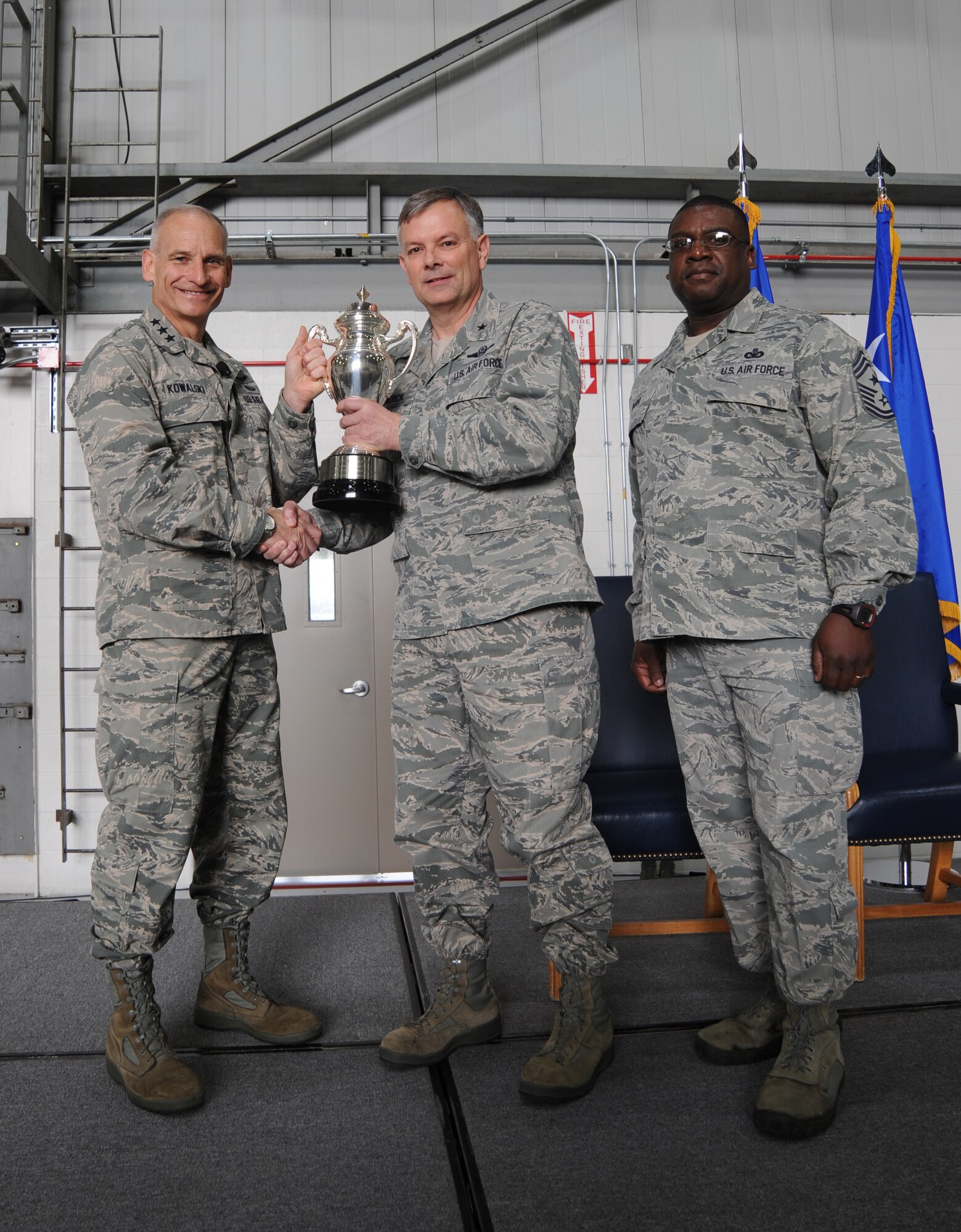 Lt. Gen. James Kowalski, U.S. Strategic Command deputy commander, presents the Omaha Trophy to Brig. Gen. Glen VanHerck, 509th Bomb Wing commander, and Chief Master Sgt. Lee Barr, 509th Bomb Wing command chief, during a ceremony at Whiteman Air Force Base, Mo., April 28, 2014. The trophy is awarded annually to four outstanding units that represent USSTRATCOM’s mission areas. Winners are selected based on formal evaluations, meritorious achievement, safety and other factors such as community involvement and humanitarian actions. USSTRATCOM relies on various task forces for the execution of its global missions, including space operations, information operations, missile defense, global command and control, intelligence, surveillance and reconnaissance (ISR), global strike and strategic deterrence, and combatting weapons of mass destruction. (U.S. Air Force photo by Senior Airman Bryan Crane/Released)