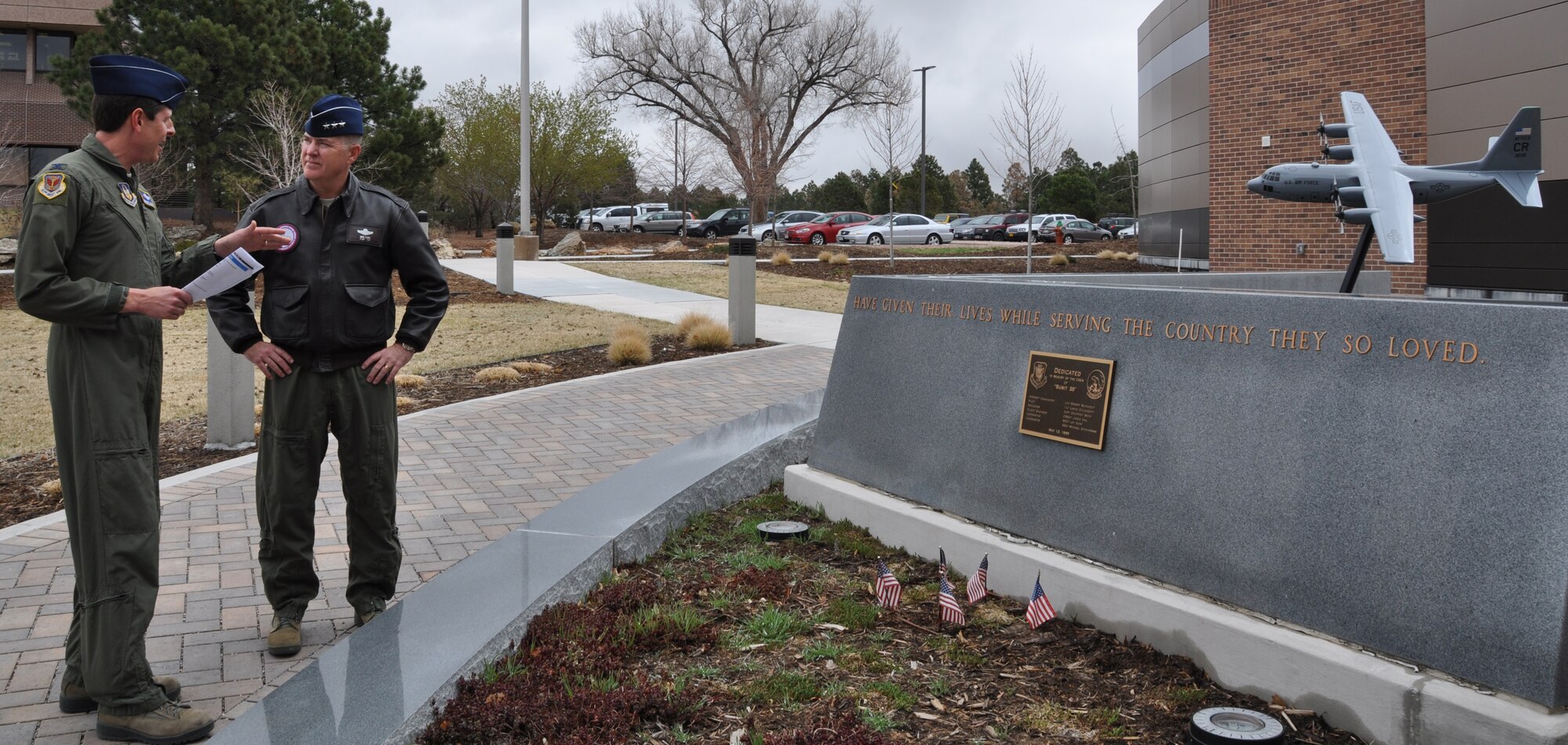 PETERSON AIR FORCE BASE, Colo. -- In view of the Sumit 38 memorial here, Col. Courtney Arnold, Commander of the 302nd Airlift Wing shares the story of the 302nd Airlift Wing Airmen who lost their lives in support of the wing’s Modular Airborne Fire Fighting mission with Lt. Gen. Michael Dubie, deputy commander of U.S. Northern Command during the combatant commander’s visit to the 302nd AW April 17, 2014. While en route to Colorado on May 13, 1995, the C-130 assigned to the 302nd AW crashed after having delivered personnel and equipment to support wildland firefighting efforts in Boise, Idaho. The Airmen who perished in the crash are: Lt. Col. Robert Buckhout; Capt. Geoffrey Boyd; 1st Lt. Lance Dougherty; Chief Master Sgt. Jimmie Vail; Master Sgt. Jay Kemp; and Staff Sgt. Michael Scheideman. (U.S. Air Force photo/Ann Skarban)
