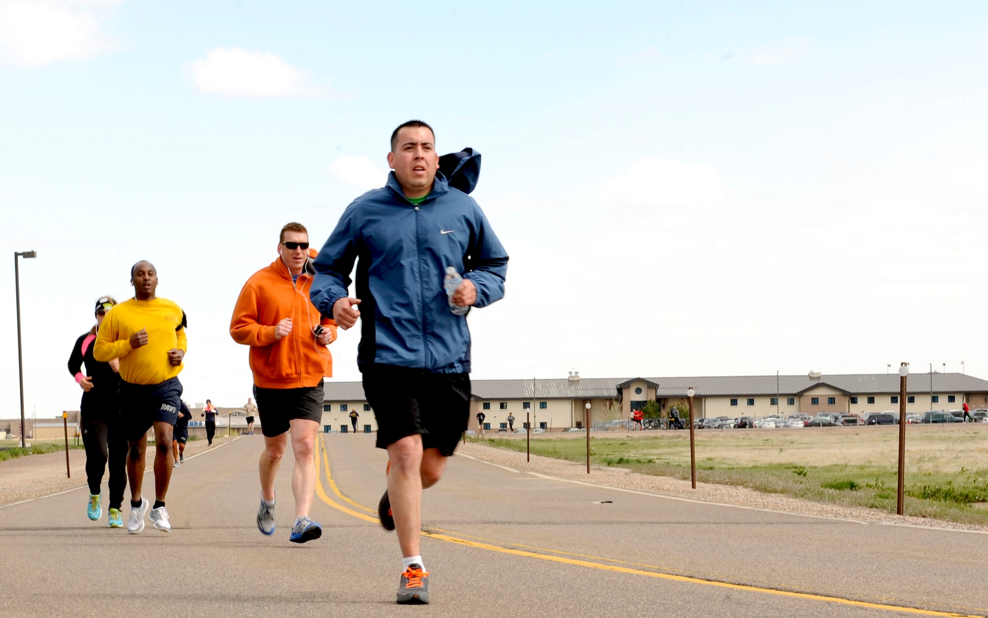 Team Buckley members wait to begin the 2nd Annual Sexual Assault Awareness 5K Fun Run April 30, 2014, at the 460th Space Wing headquarters building on Buckley Air Force Base, Colo. The race brought service members, family and friends together to raise awareness for sexual assault prevention. (U.S. Army photo by Spc. Kristin Stoneback/Released)