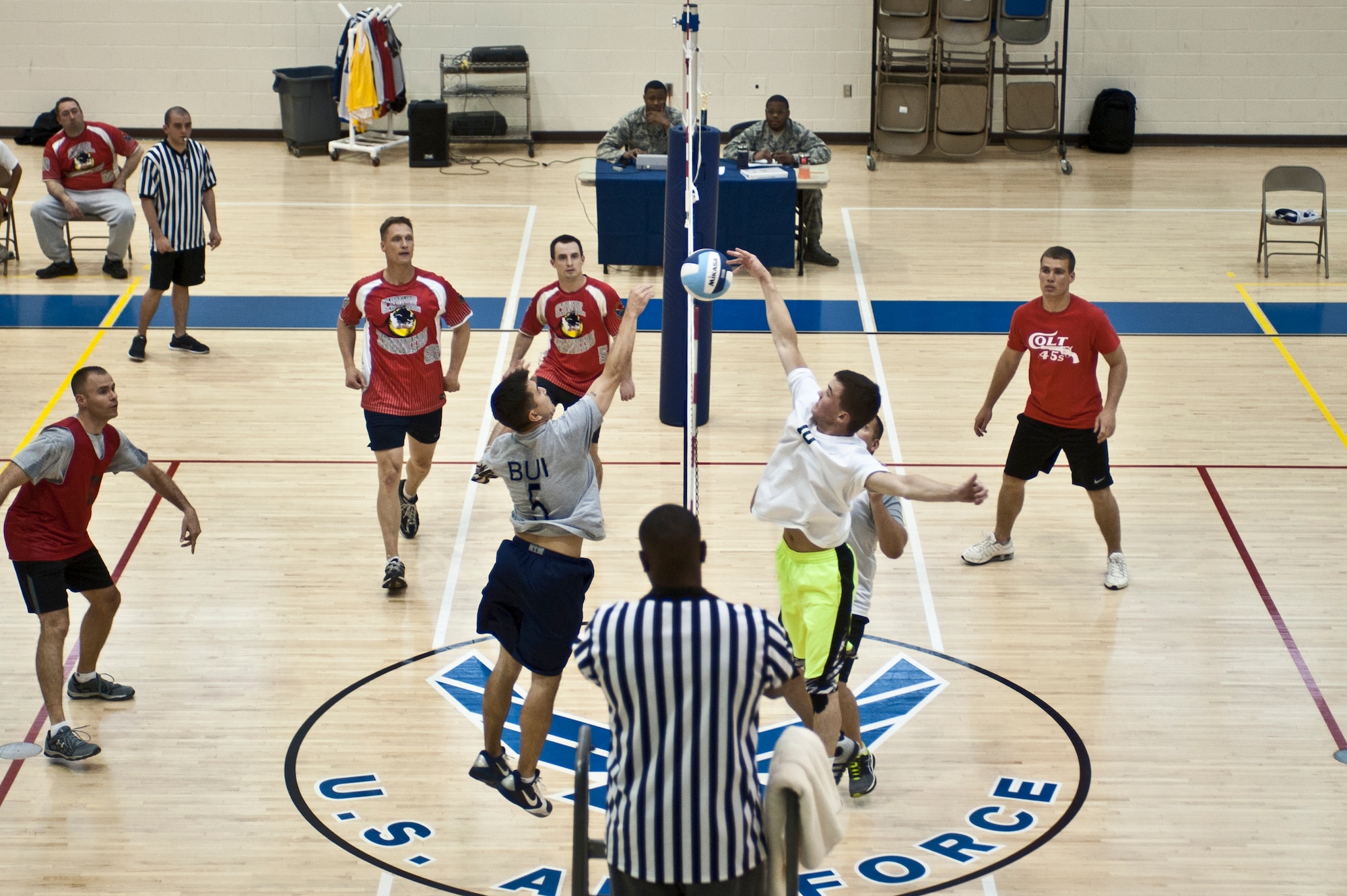 The 45th Intelligence Squadron team squares off against the 633rd Civil Engineer Squadron team during the intramural volleyball championship game at Langley Air Force Base, Va., April 29, 2014. The 45th IS team reached the championship after an undefeated season. (U.S. Air Force photo by Staff Sgt. Stephanie R. Plichta/Released) 