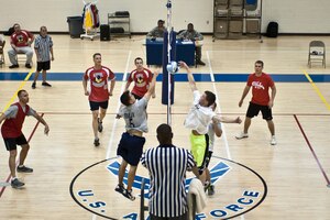The 45th Intelligence Squadron team squares off against the 633rd Civil Engineer Squadron team during the intramural volleyball championship game at Langley Air Force Base, Va., April 29, 2014. The 45th IS team reached the championship after an undefeated season. (U.S. Air Force photo by Staff Sgt. Stephanie R. Plichta/Released) 