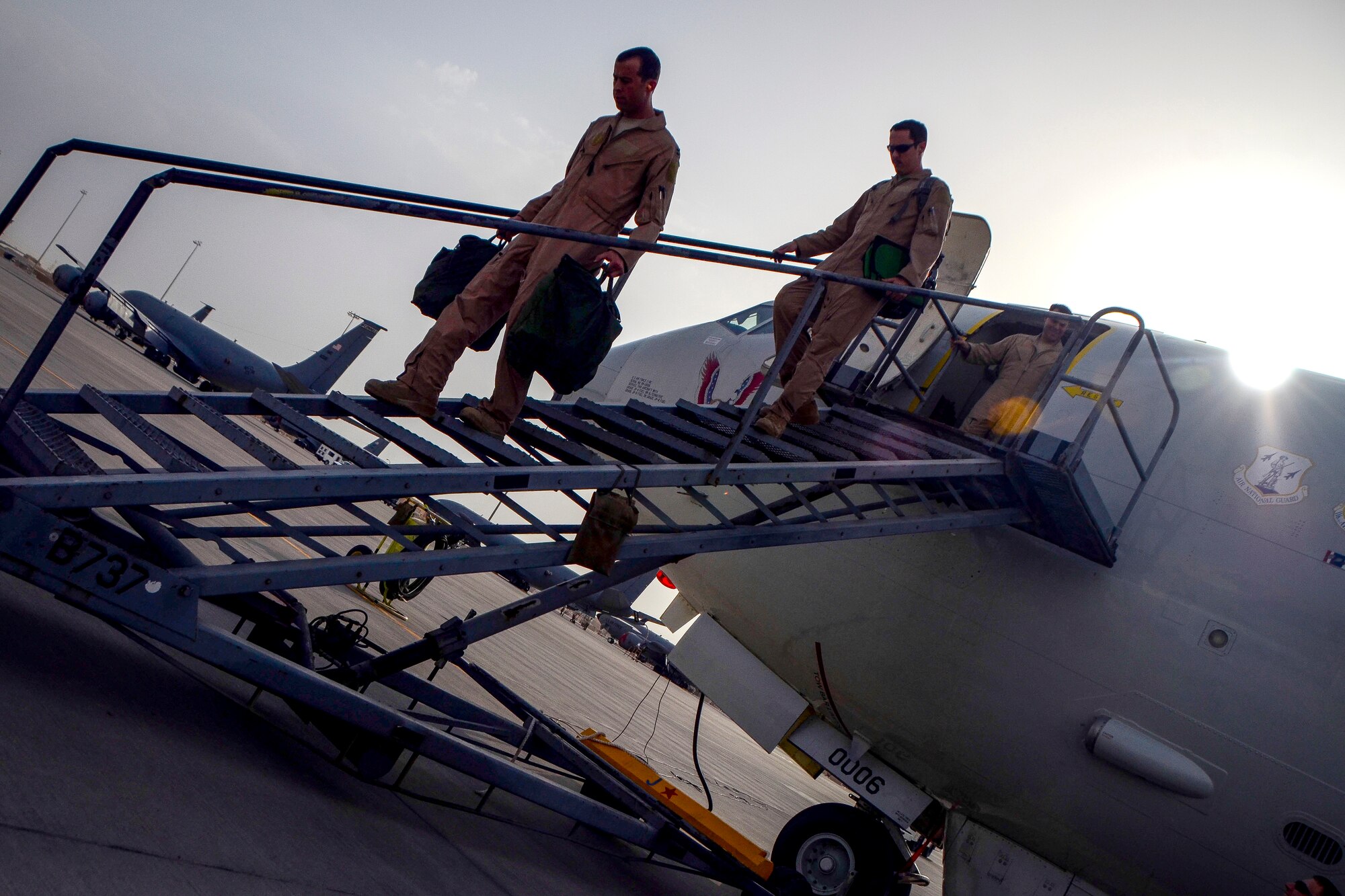 Mission crew of an E-8C Joint Surveillance Target Attack Radar System deplane at Al Udeid Air Base, Qatar, May 1, 2014, after reaching a milestone of 100,000 flying hours to include more than 88,000 hours in the U.S. Central Command area of responsibility since 2001. The JSTARS mission is to provide ground commanders with intelligence, surveillance and reconnaissance air power to boost force protection, defensive operations, over-watch and combat search and rescue missions throughout the AOR.  (U.S. Air Force photo/Senior Airman Jared Trimarchi)