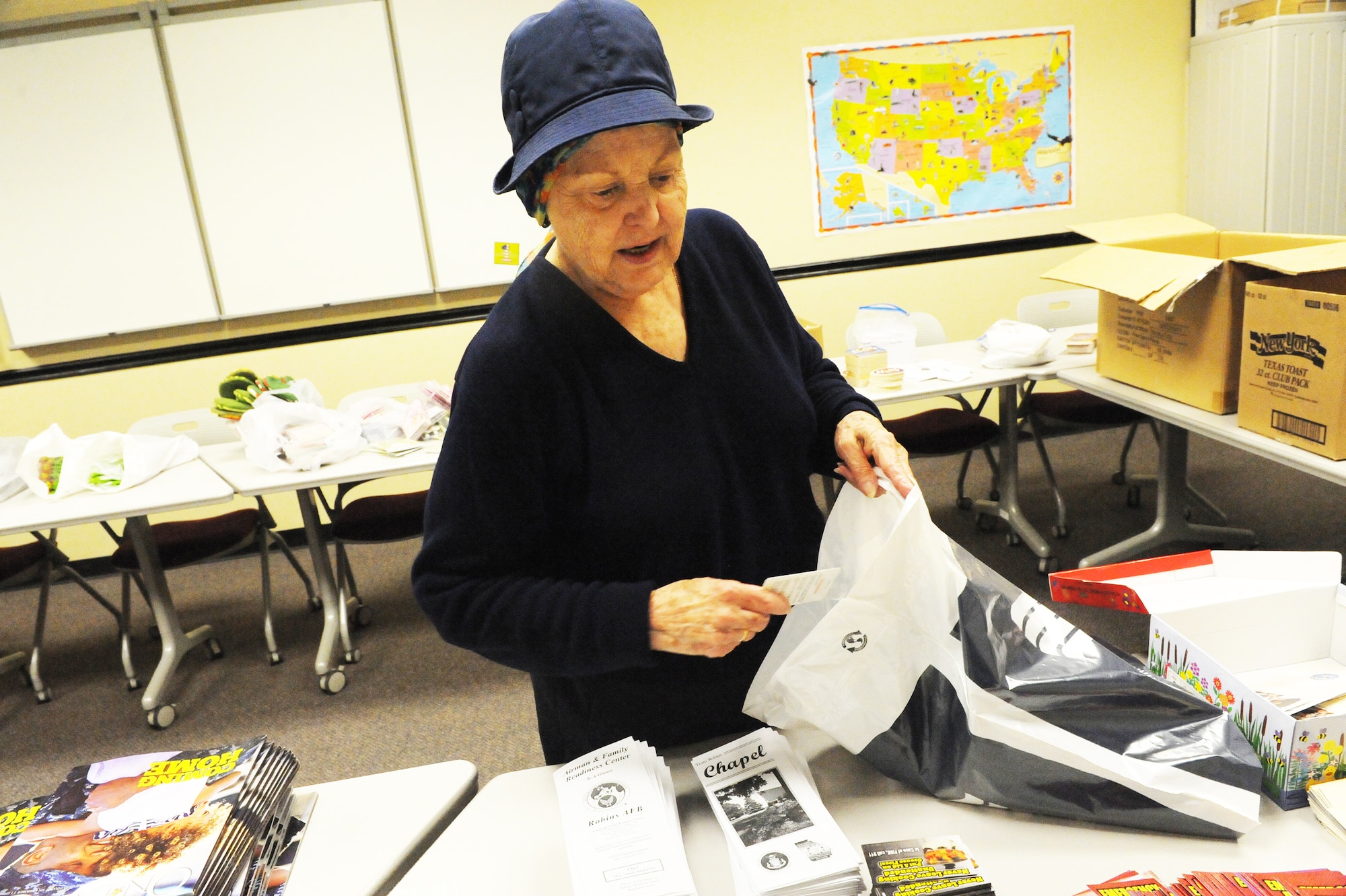 Becky Anderson, USO director, and other USO volunteers put together gift bags for military spouses. U.S. Air Force photo by Ray Crayton