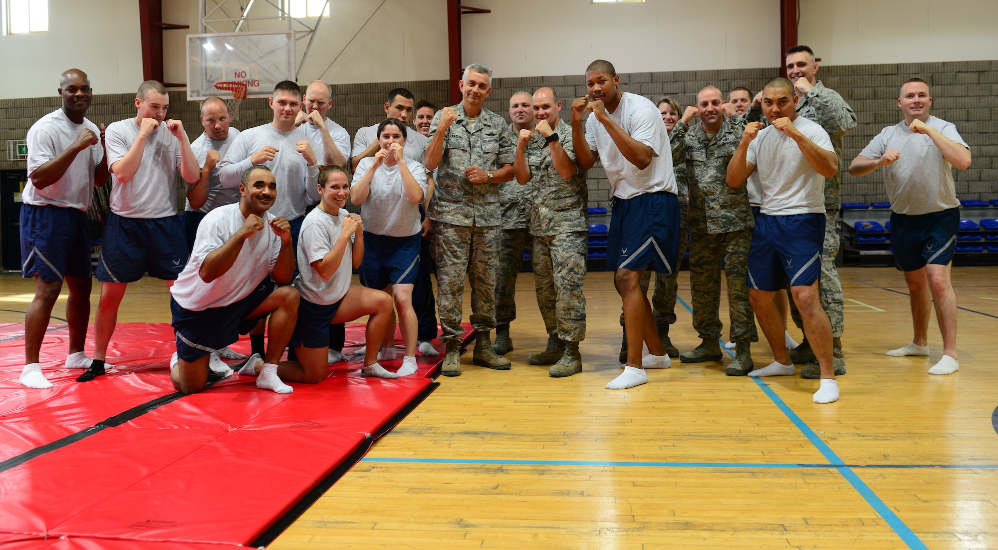 Brig. Gen. Roger H. Watkins 379th Air Expeditionary Wing commander, poses for a group photo with class participants after a combatives training class at Al Udeid Air Base, Qatar, April 29, 2014. The class is offered four times a week, Monday and Wednesday from 8-10a.m., and Wednesday and Fridays from 7-9 p.m. (U.S. Air Force photo by Staff Sgt. Ciara Wymbs)  

