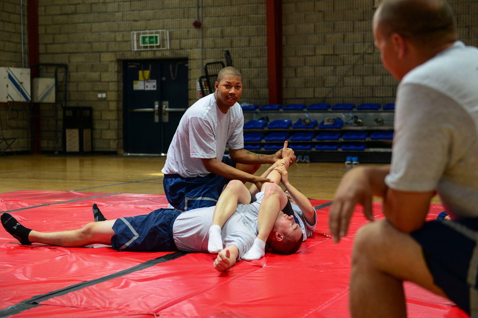 Staff Sgt. Xavier Drake, 379th Air Expeditionary Wing Force Protection Check Six instructor, demonstrates an arm bar from mount position during a combatives training class at Al Udeid Air Base, Qatar, April 29, 2014. The arm bar from mount is a technique that allows you to submit your opponent from the mounted position. Drake is deployed from Altus Air Force Base, Okla., and hails from Washington, D.C. (U.S. Air Force photo by Staff Sgt. Ciara Wymbs)


